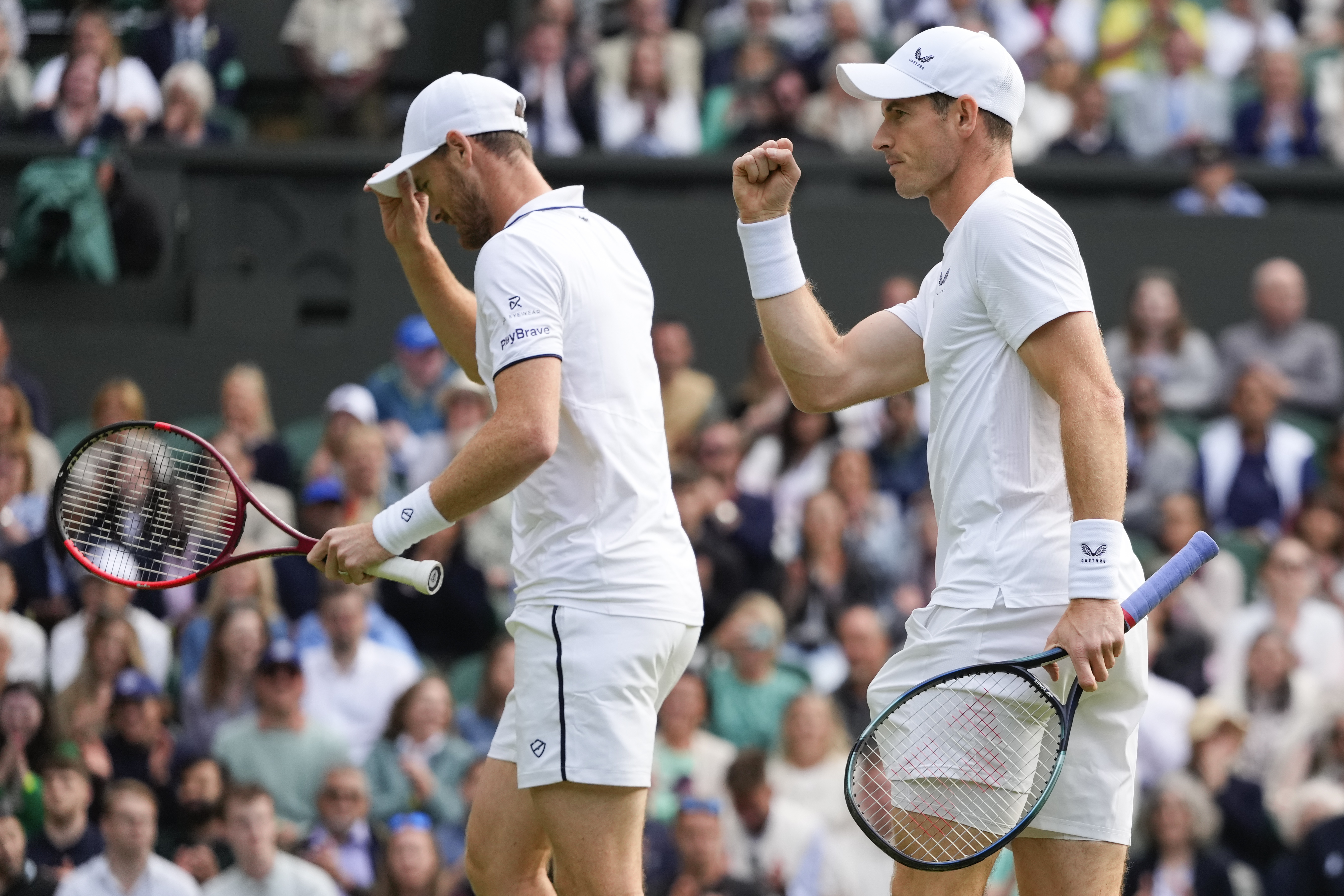 Andy, right, and Jamie Murray react during their first round doubles match against Australia's John Peers and Ricky Hijikata at the Wimbledon tennis championships in London, Thursday, July 4, 2024.