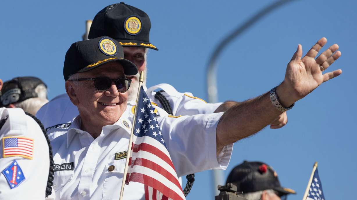 Parade participants wave during the Freedom Festival Grand Parade in Provo on Thursday.