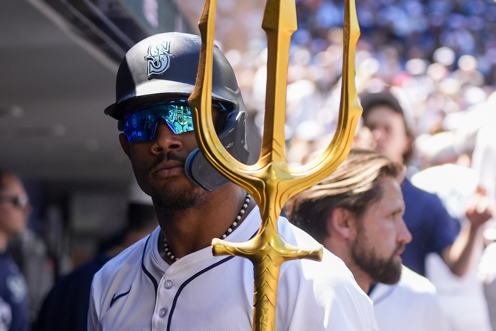 Seattle Mariners' Julio Rodríguez holds a trident in the dugout after his solo home run against the Baltimore Orioles during the fifth inning of a baseball game Thursday, July 4, 2024, in Seattle. 
