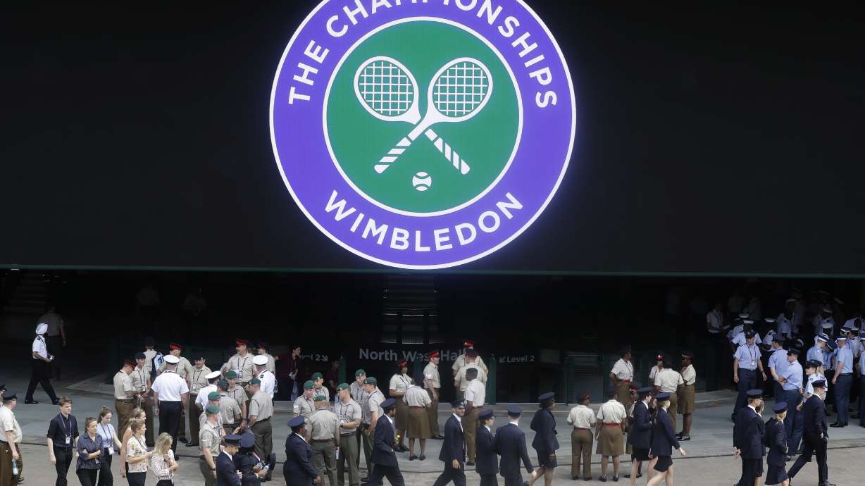 FILE - Stewards prepare for the start of the Wimbledon Tennis Championships in London, Sunday, June 30, 2019. This year's Wimbledon tournament begins on Monday, July 1.