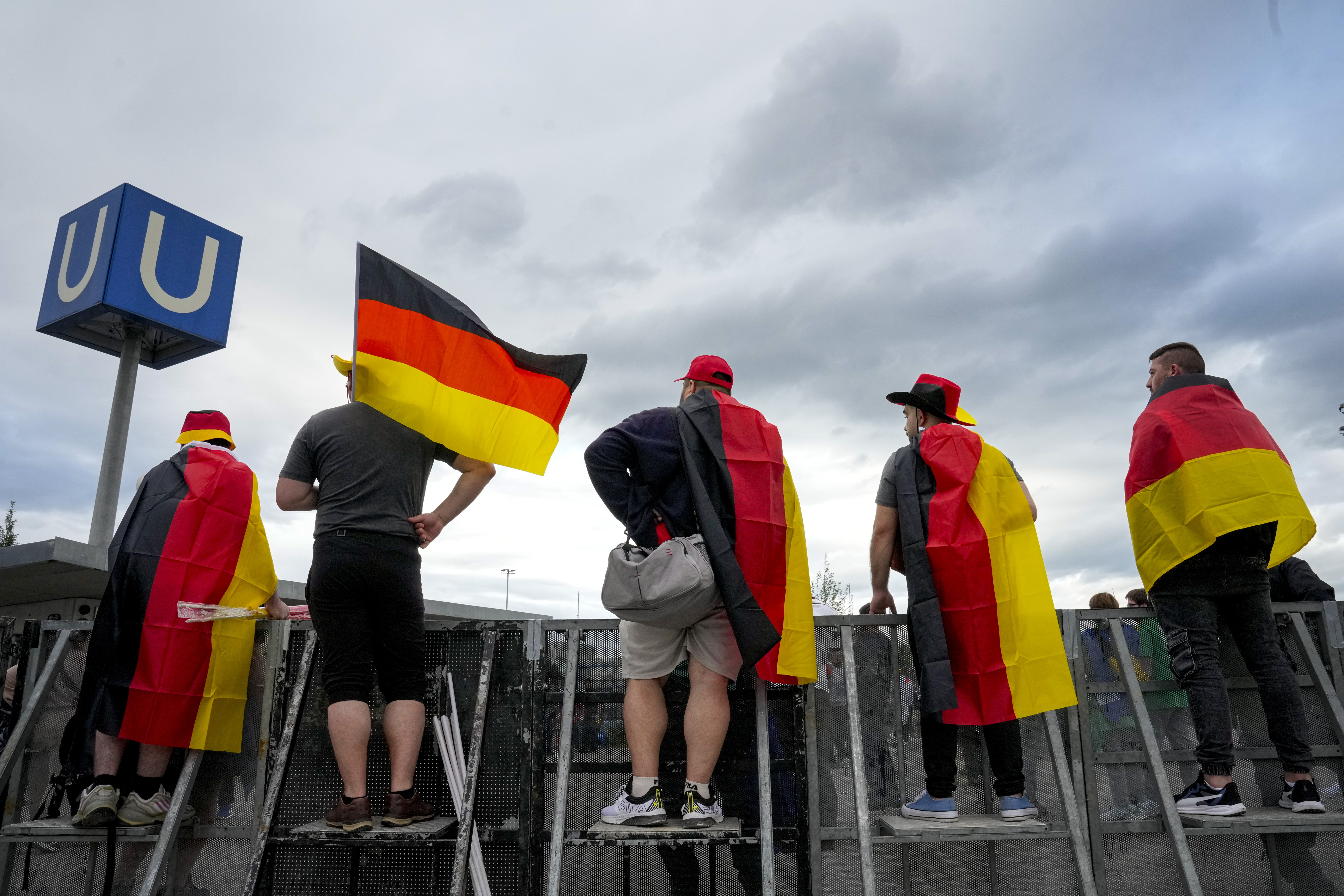 Germany's soccer team fans wave flags before a Group A match between Germany and Scotland at the Euro 2024 soccer tournament in Munich, Germany, Friday, June 14, 2024.