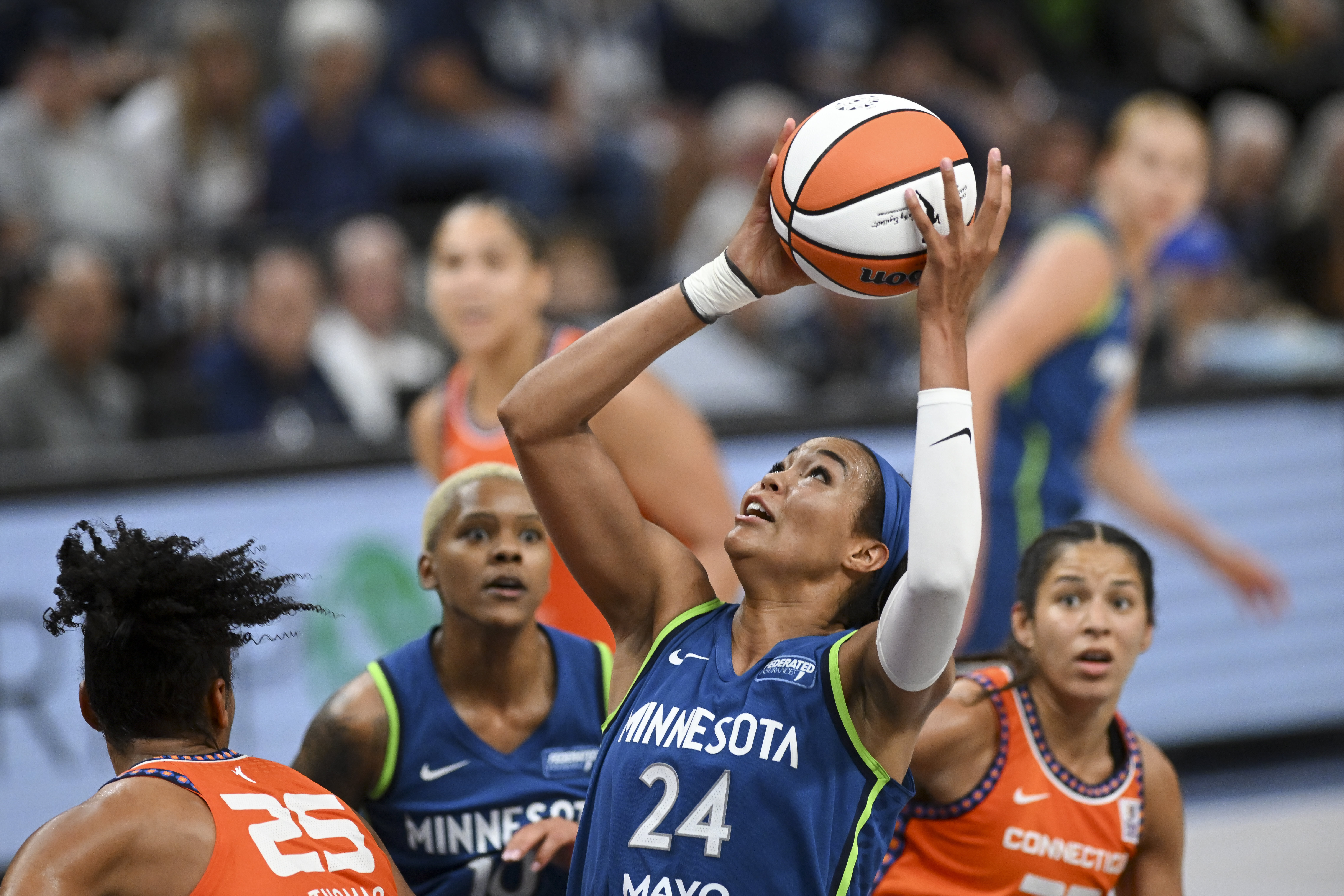 Minnesota Lynx forward Napheesa Collier (24) pulls down a rebound against the Connecticut Sun during the second half of a WNBA basketball game, Thursday, July 4, 2024 in Minneapolis. 