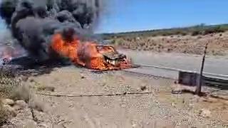 A pickup is covered in flames and black smoke on northbound Interstate 15 New Harmony, Thursday.