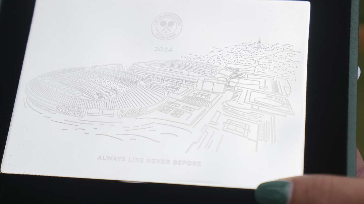 Jessica Pegula of the United States holds the sterling silver plaques players receive at Wimbledon in London, Sunday, June 30, 2024.In a relatively well-kept secret — even some athletes were completely unaware when asked about the keepsakes by The Associated Press during the tournament that wraps up next weekend — the All England Club distributes the mementos to all 256 players in the women's and men's singles brackets, as well as those in doubles and wheelchair events.