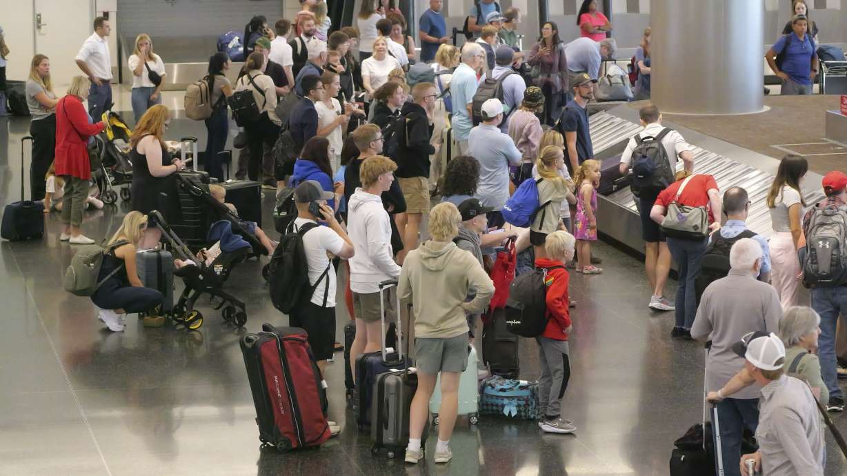 Holiday travelers wait for their luggage after arriving at Salt Lake City International Airport Wednesday, in Salt Lake City. Travelers say air travel is getting more miserable, based on the number of them who filed complaints with the government last year.