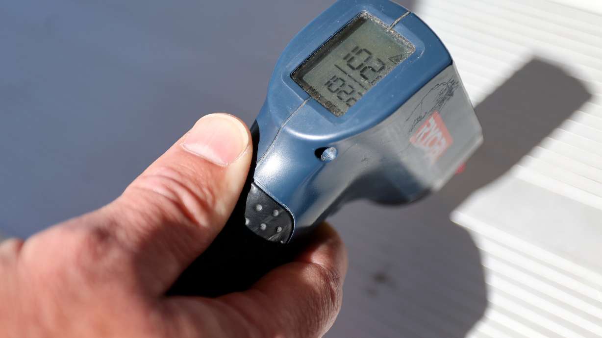 Salt Lake Fire Capt. Brandt Hancuff measures the temperature of a picnic table on Tuesday. A "heat dome" is expected to produce excessive heat in southern Utah, while triple-digit temperatures are forecast to return to the Wasatch Front next week.