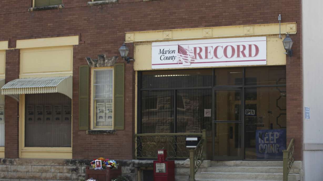 A former reporter for Marion County Record, a weekly Kansas newspaper, has agreed to accept $235,000 to settle part of her federal lawsuit over a police raid on the paper.