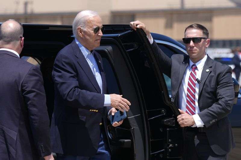 President Joe Biden, center, arrives to board Air Force One at Andrews Air Force Base, Md., as he leaves for a campaign trip to Madison, Wis., Friday.