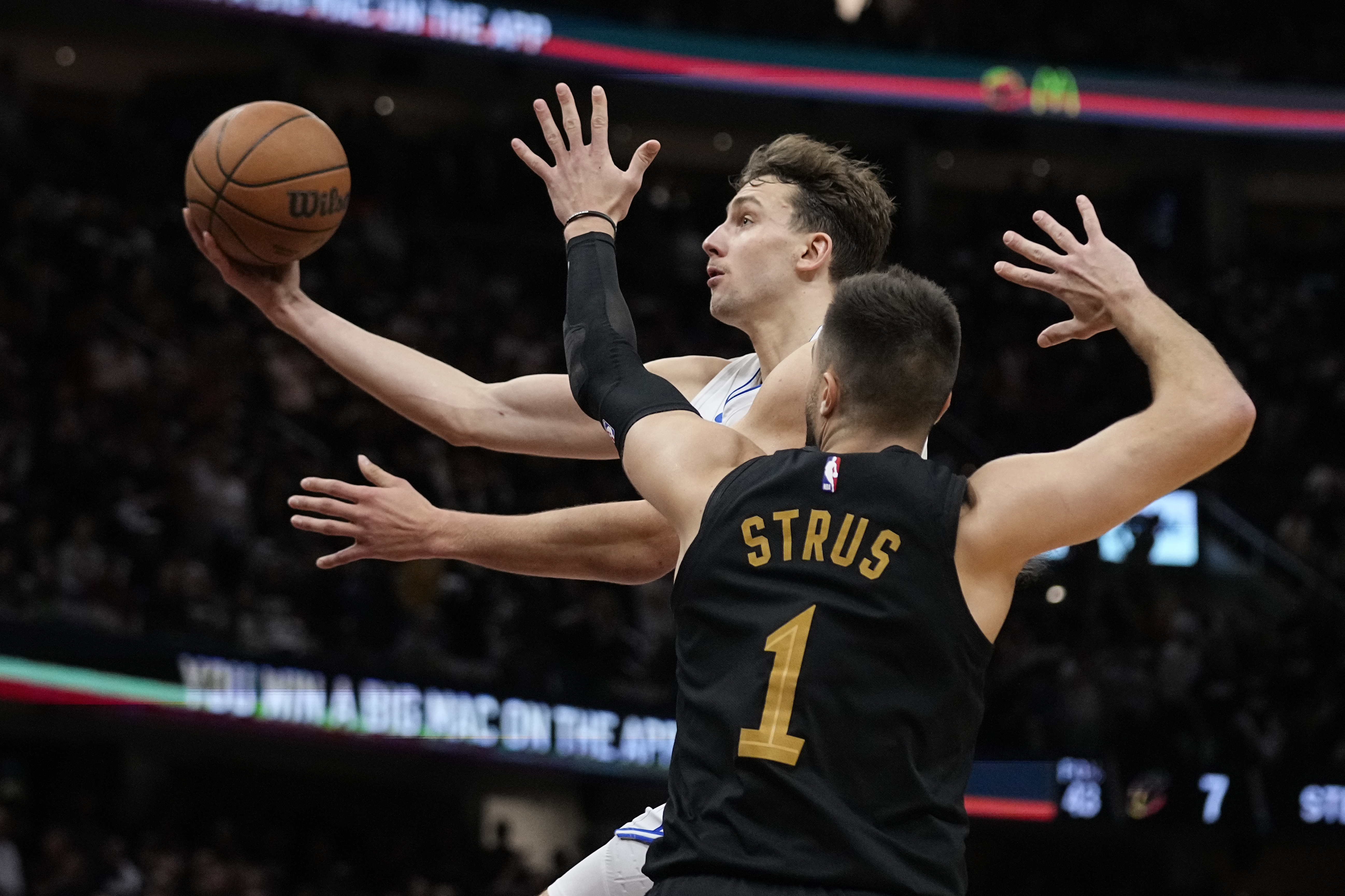 FILE = Orlando Magic forward Franz Wagner, left, goes to the basket past Cleveland Cavaliers guard Max Strus (1) in the second half of Game 7 of an NBA basketball first-round playoff series, Sunday, May 5, 2024, in Cleveland. Franz Wagner has agreed to the largest contract in Orlando Magic history, a five-year extension that will be worth at least $224 million, a person with knowledge of the negotiations told The Associated Press on Friday, July 5, 2024.