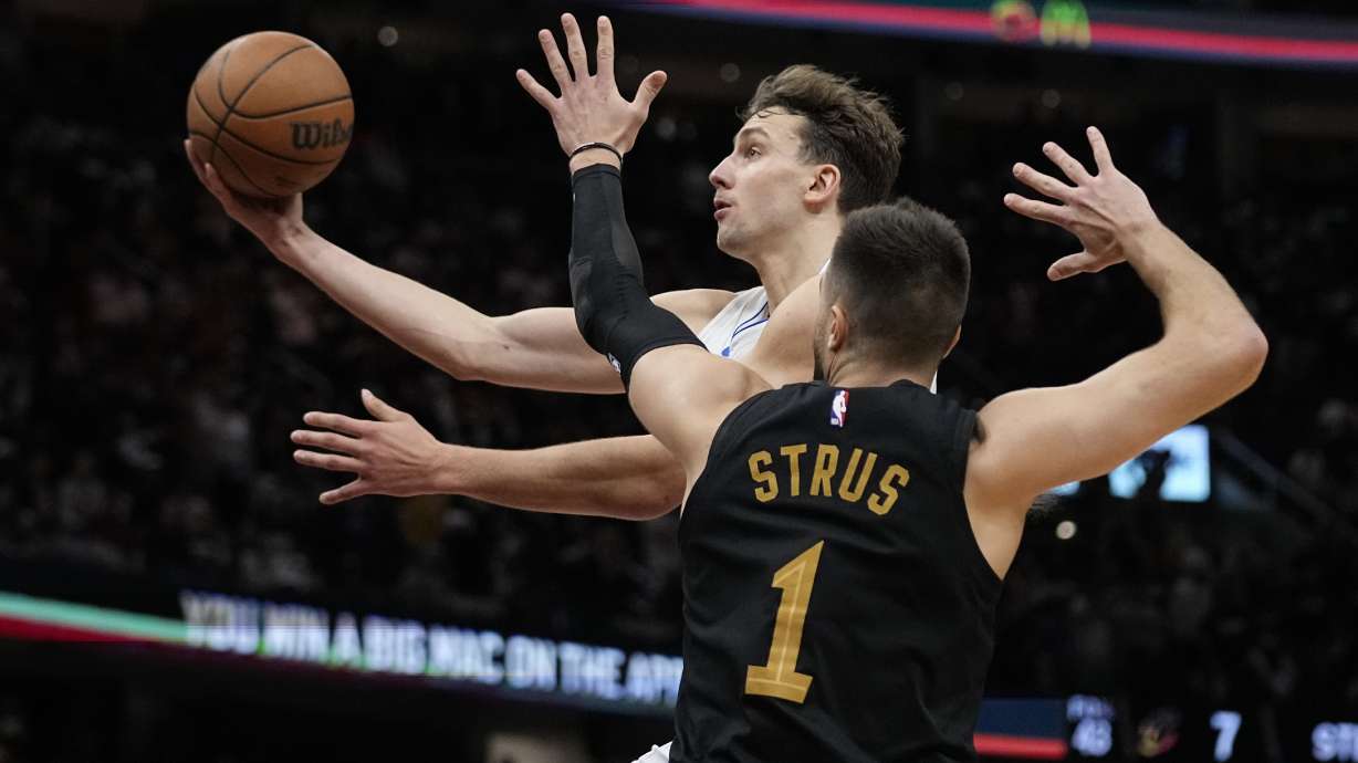 FILE = Orlando Magic forward Franz Wagner, left, goes to the basket past Cleveland Cavaliers guard Max Strus (1) in the second half of Game 7 of an NBA basketball first-round playoff series, Sunday, May 5, 2024, in Cleveland. Franz Wagner has agreed to the largest contract in Orlando Magic history, a five-year extension that will be worth at least $224 million, a person with knowledge of the negotiations told The Associated Press on Friday, July 5, 2024.