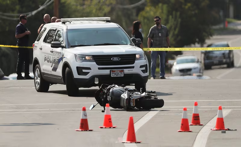 A motorcycle is pictured in the road a members of law enforcement investigate a police shooting at 4500 South and 2300 East in Holladay on Sept. 17, 2020.