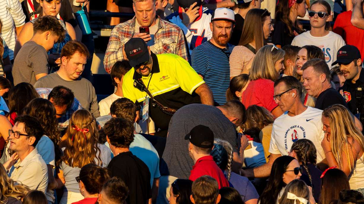 The crowd watches as a member of Provo Fire and Rescue searches for an injured individual after an errant firework exploded among attendees during Stadium of Fire held at LaVell Edwards Stadium in Provo on Thursday.