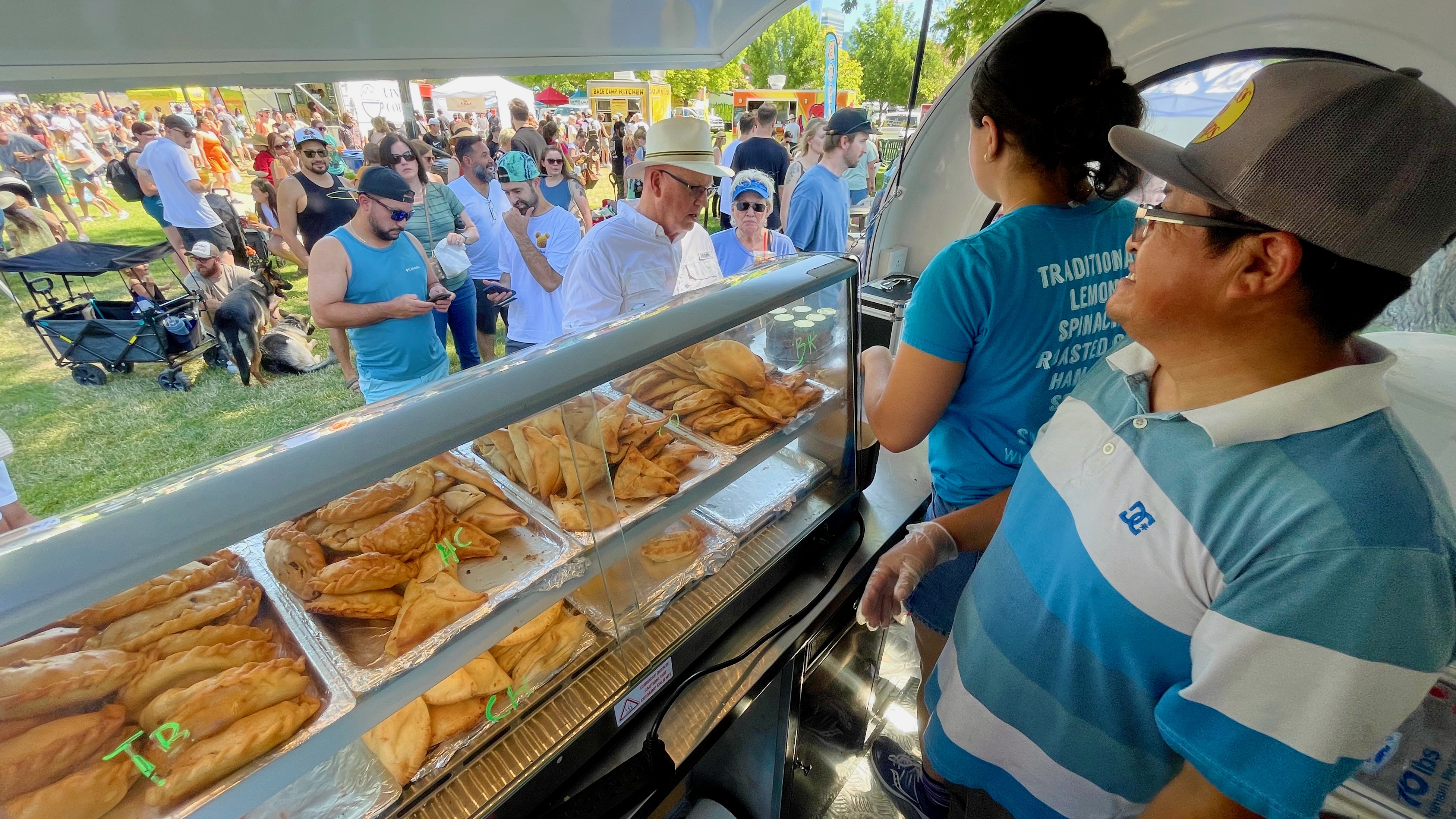 Cesar Maldonado, right, and Francisca Moreira sell Argentina's Best Empanadas food at the Downtown Farmers Market in Salt Lake on June 22.