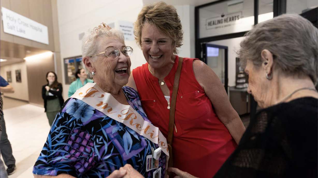 Wilene Lowther greets her friends Violet Vicchrilli and Robbyn Oliver as they celebrate her retirement after 65 years of service and bid her farewell at CommonSpirit Holy Cross Hospital in Salt Lake City on Monday.