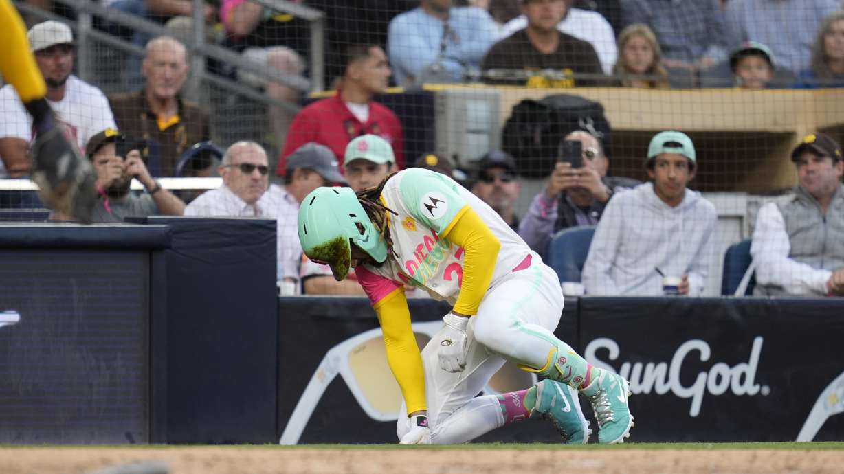 San Diego Padres' Fernando Tatis Jr. takes a moment after being hit by a pitch during the third inning of a baseball game against the Milwaukee Brewers, Friday, June 21, 2024, in San Diego.