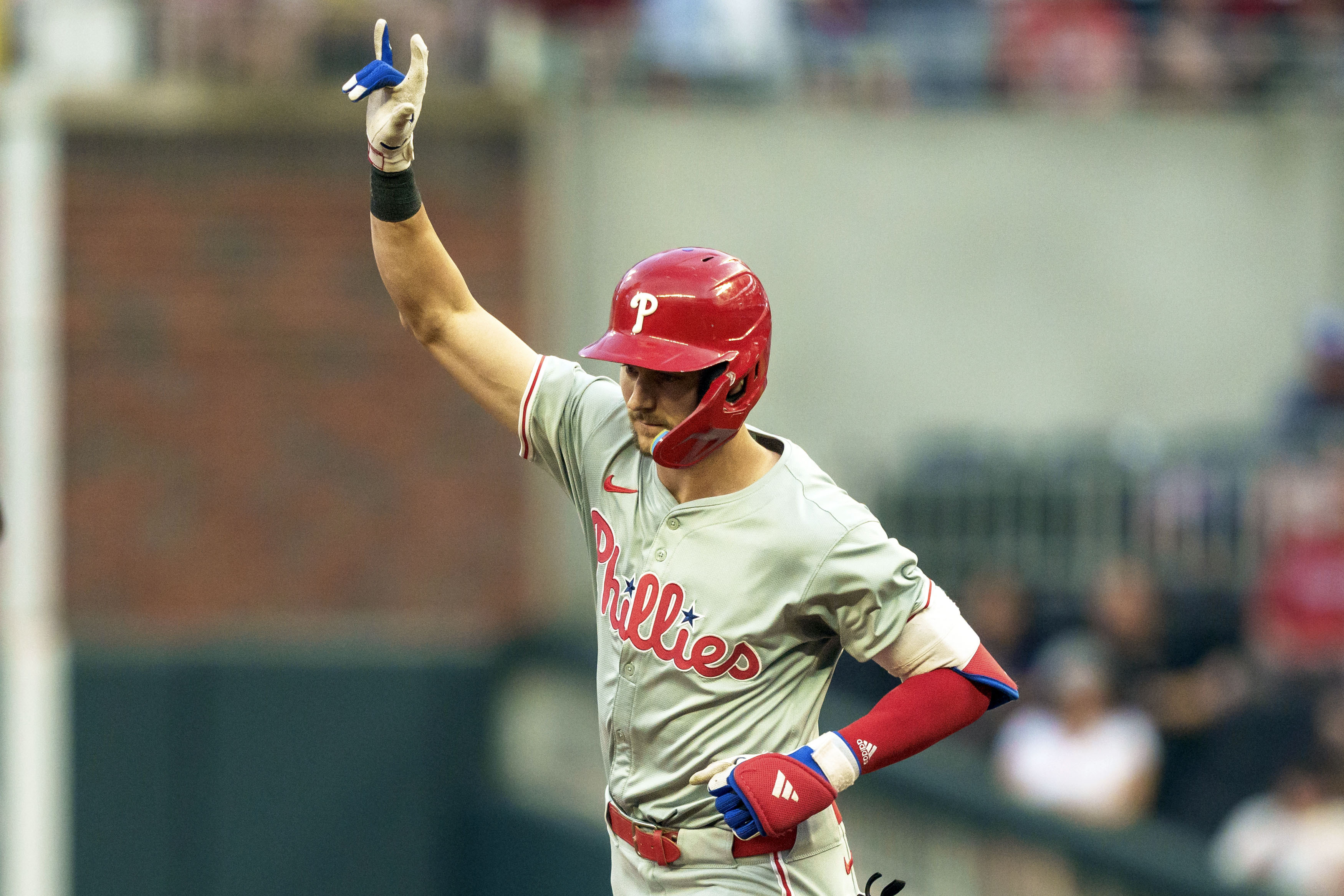 Philadelphia Phillies shortstop Trea Turner waves to the crowd while rounding second base after hitting a home run in the fourth inning of a baseball game against the Atlanta Braves, Friday, July 5, 2024, in Atlanta. 