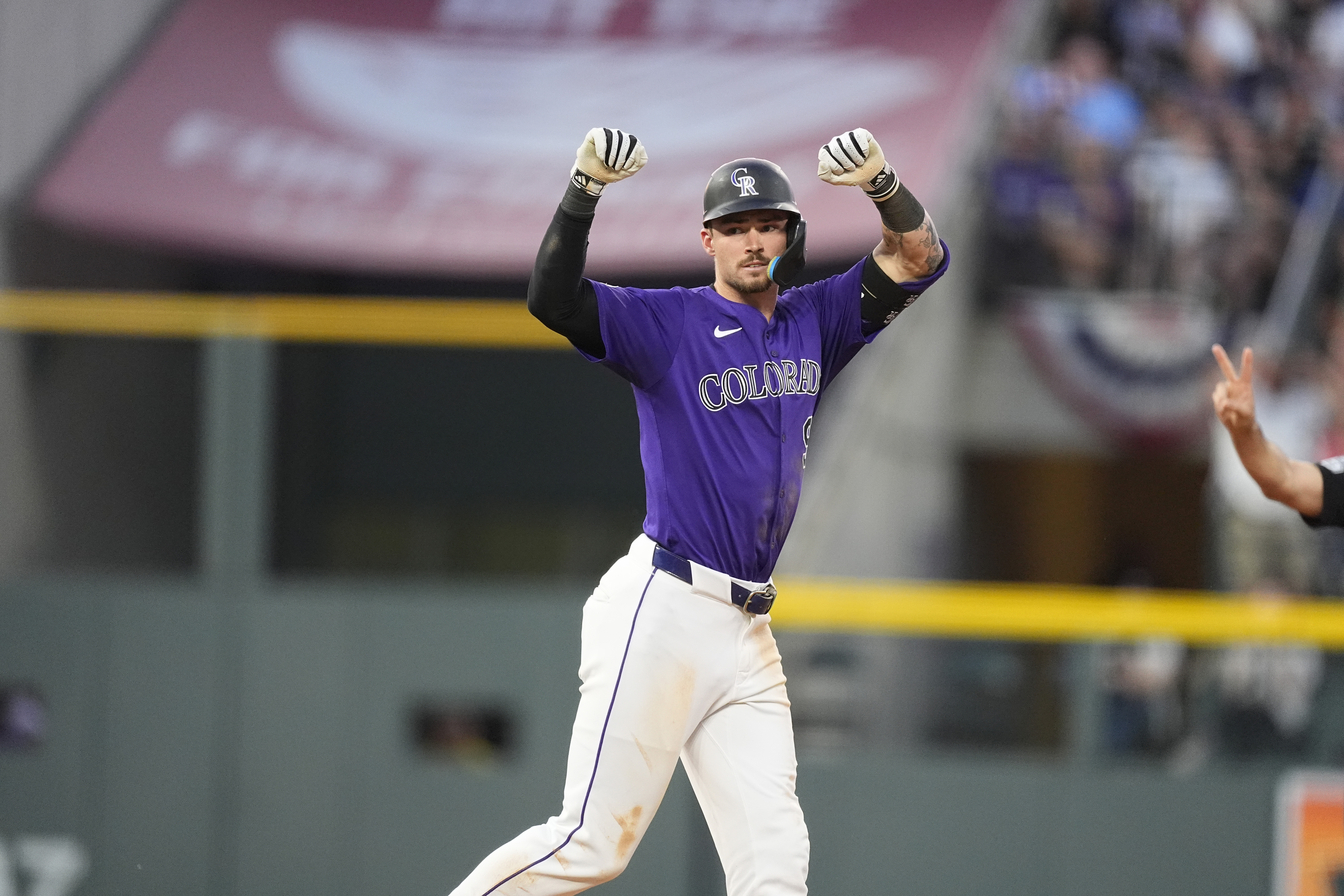Colorado Rockies' Brenton Doyle gestures to the dugout after hitting a double to drive in two runs off Kansas City Royals relief pitcher John Schreiber in the eighth inning of a baseball game Friday, July 5, 2024, in Denver.