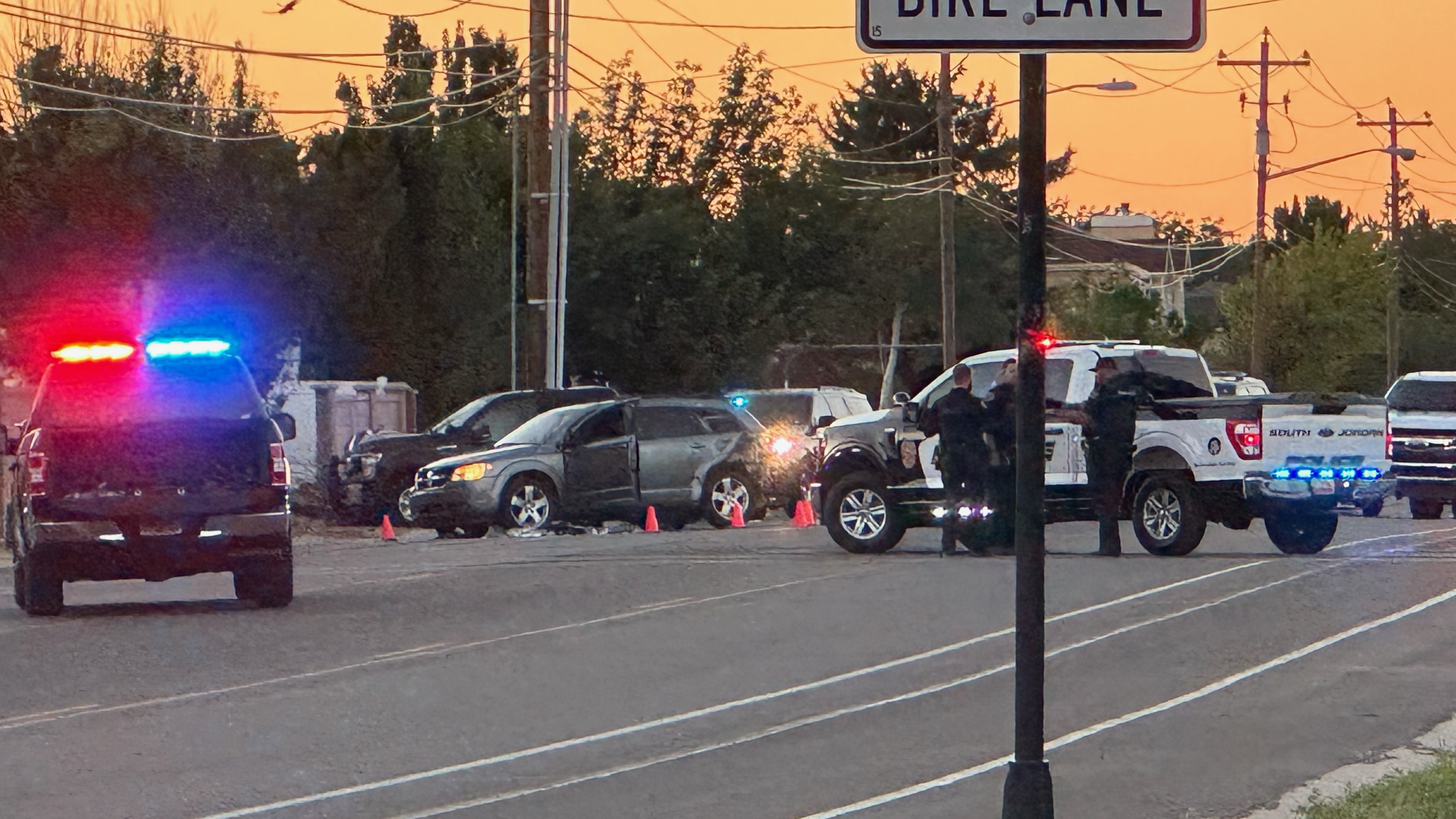Police officers investigate a shooting in West Jordan on Friday evening.