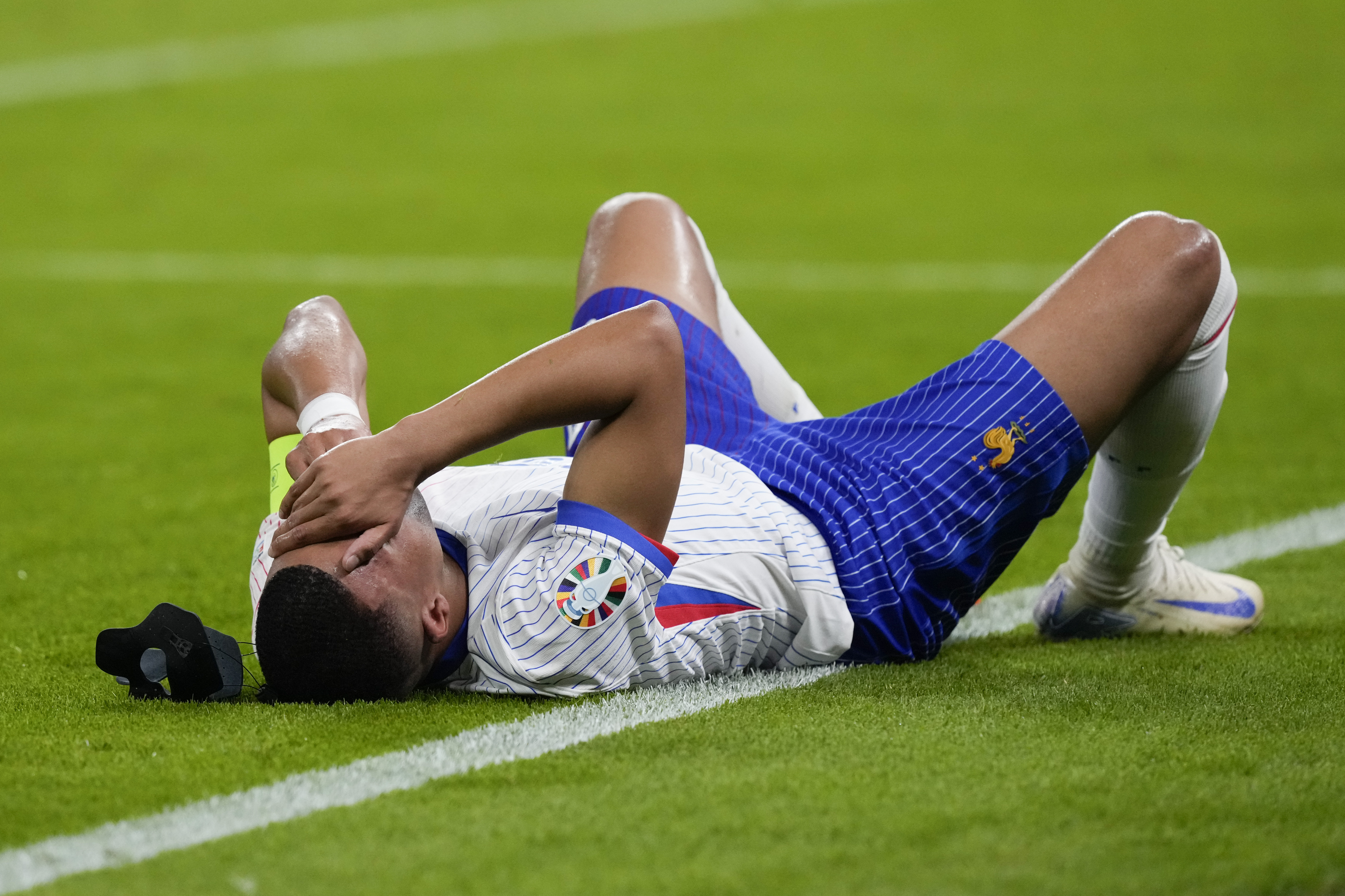 Kylian Mbappe of France reacts after an injury during a quarter final match between Portugal and France at the Euro 2024 soccer tournament in Hamburg, Germany, Friday, July 5, 2024. 
