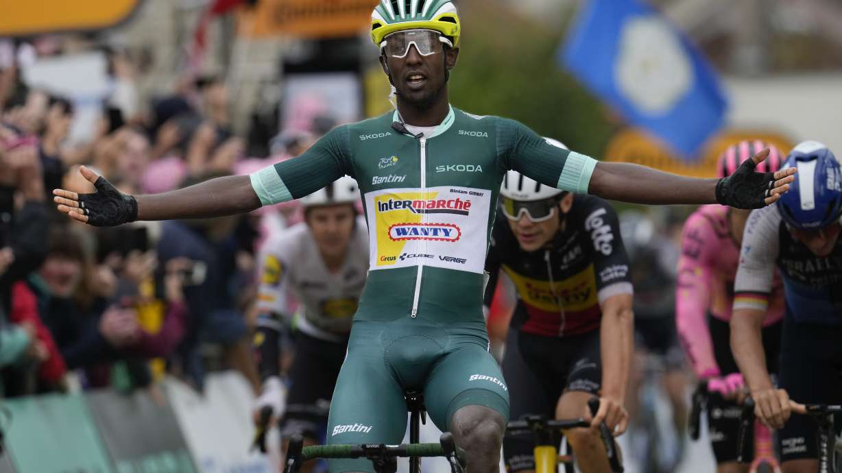 Eritrea's Biniam Girmay crosses the finish line to win the eighth stage of the Tour de France cycling race over 183.4 kilometers (114 miles) with start in Semur-en-Auxois and finish in Colombey-les-Deux-Eglises, France, Saturday, July 6, 2024.
