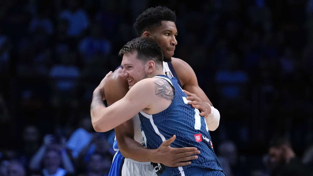 Greece's Giannis Antetokounmpo, rear, hugs Slovenia's Luka Doncic ahead of a basketball match, during the Acropolis basketball tournament at the Peace and Friendship indoor stadium at Athens' port city of Piraeus, Saturday, July 6, 2024.