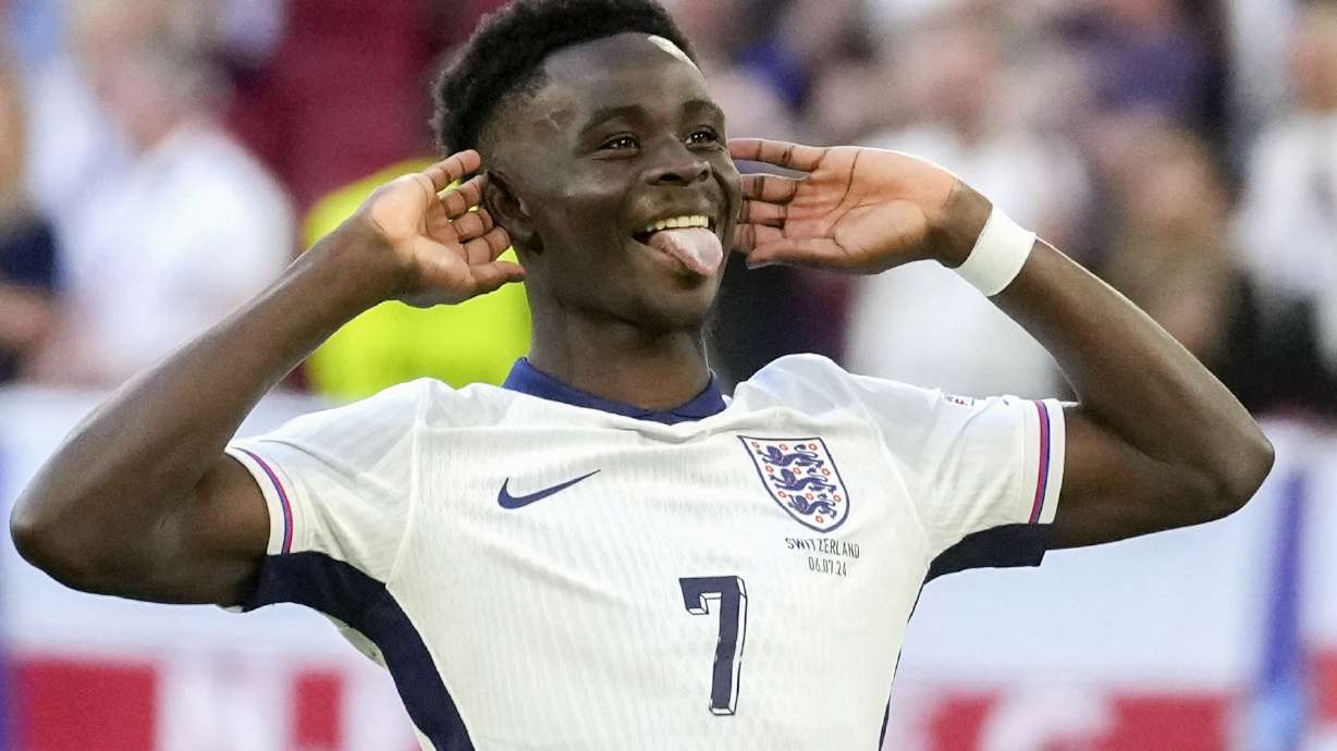 England's Bukayo Saka reacts after scoring by penalty during a quarterfinal match between England and Switzerland at the Euro 2024 soccer tournament in Duesseldorf, Germany, Saturday, July 6, 2024.