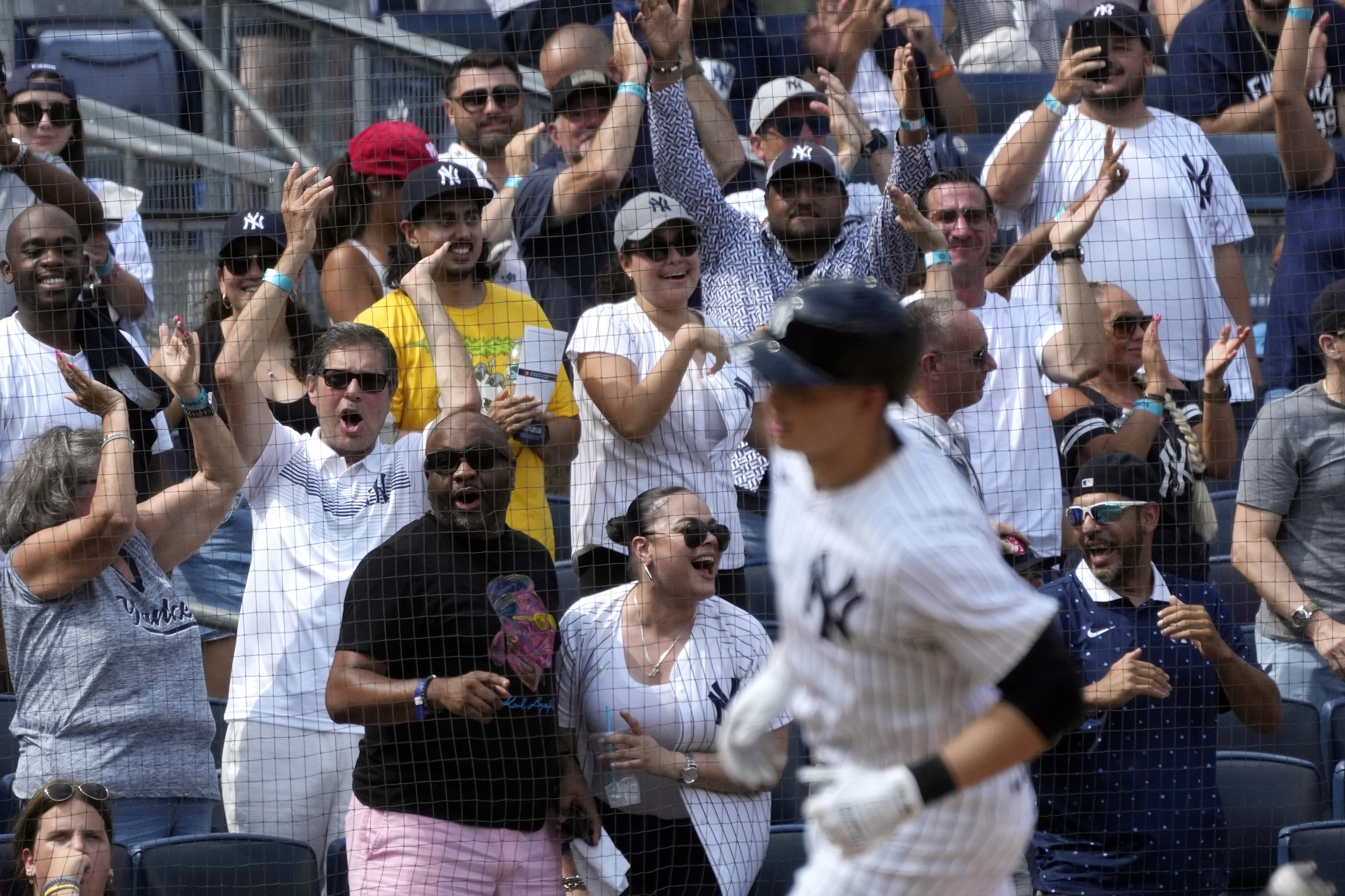 Fans react as New York Yankees' Ben Rice runs home after hitting a home run during the seventh inning of a baseball game against the Boston Red Sox, Saturday, July 6, 2024, in New York.