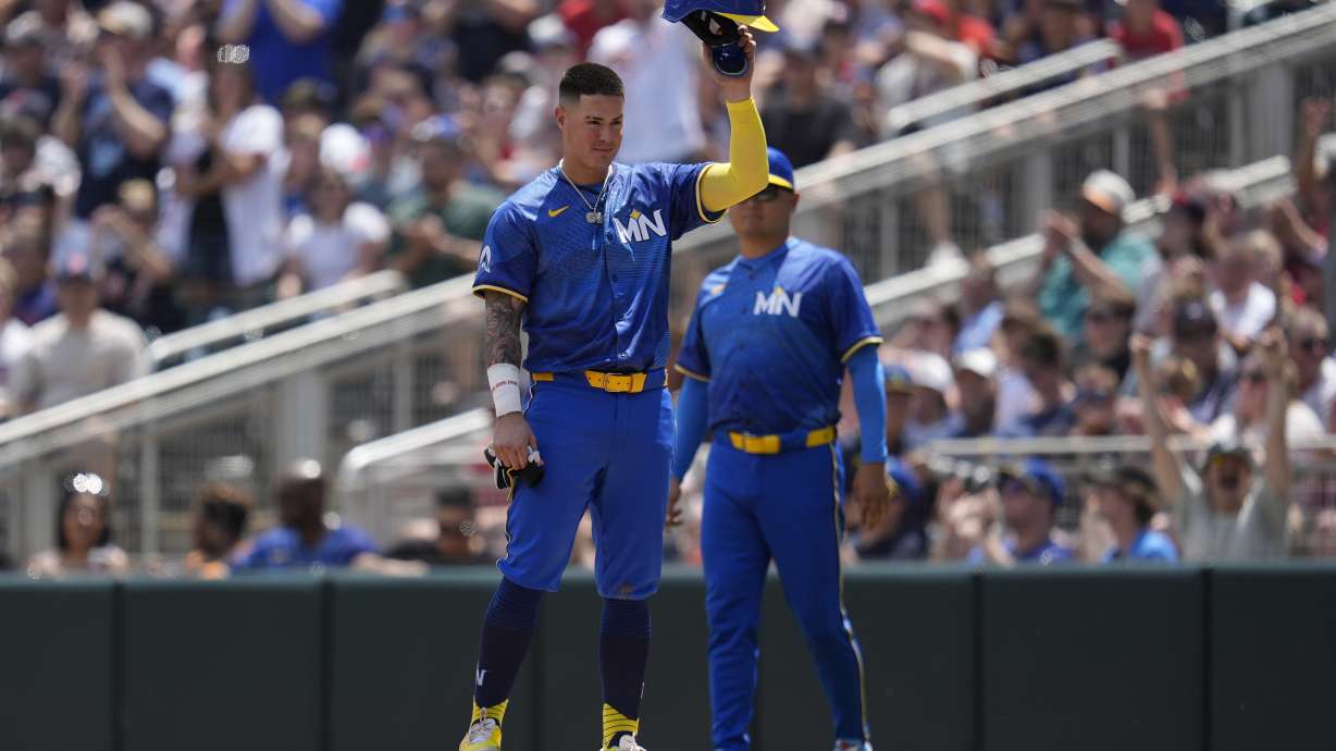 Minnesota Twins' Jose Miranda tips his helmet after setting a Twins record for reaching base safely in 12 consecutive plate appearances during the second inning of a baseball game against the Houston Astros, Saturday, July 6, 2024, in Minneapolis.