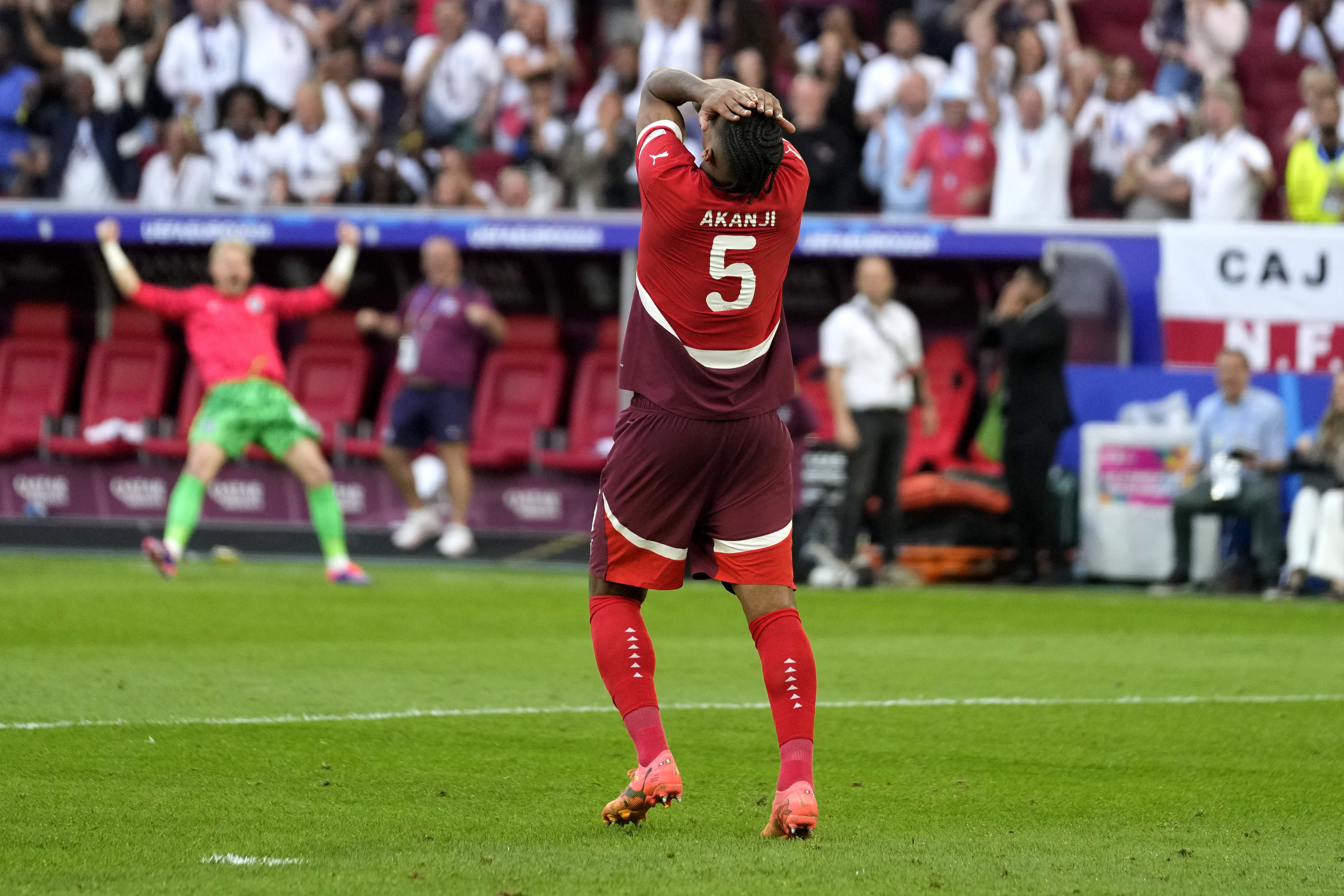 Switzerland's Manuel Akanji reacts after missing to score by penalty during a quarterfinal match between England and Switzerland at the Euro 2024 soccer tournament in Duesseldorf, Germany, Saturday, July 6, 2024. 