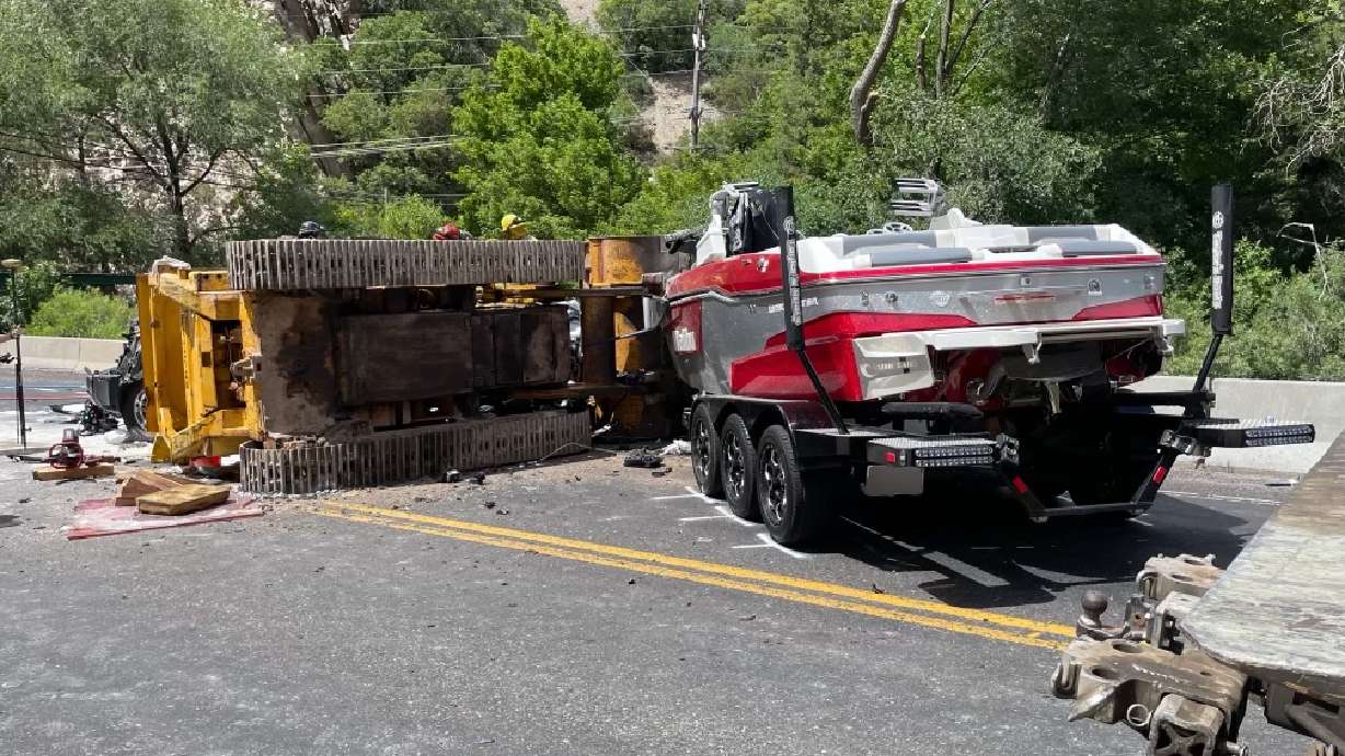 Two people were killed and three others injured when an SUV collided with a bulldozer being transported up Ogden Canyon on Saturday afternoon.