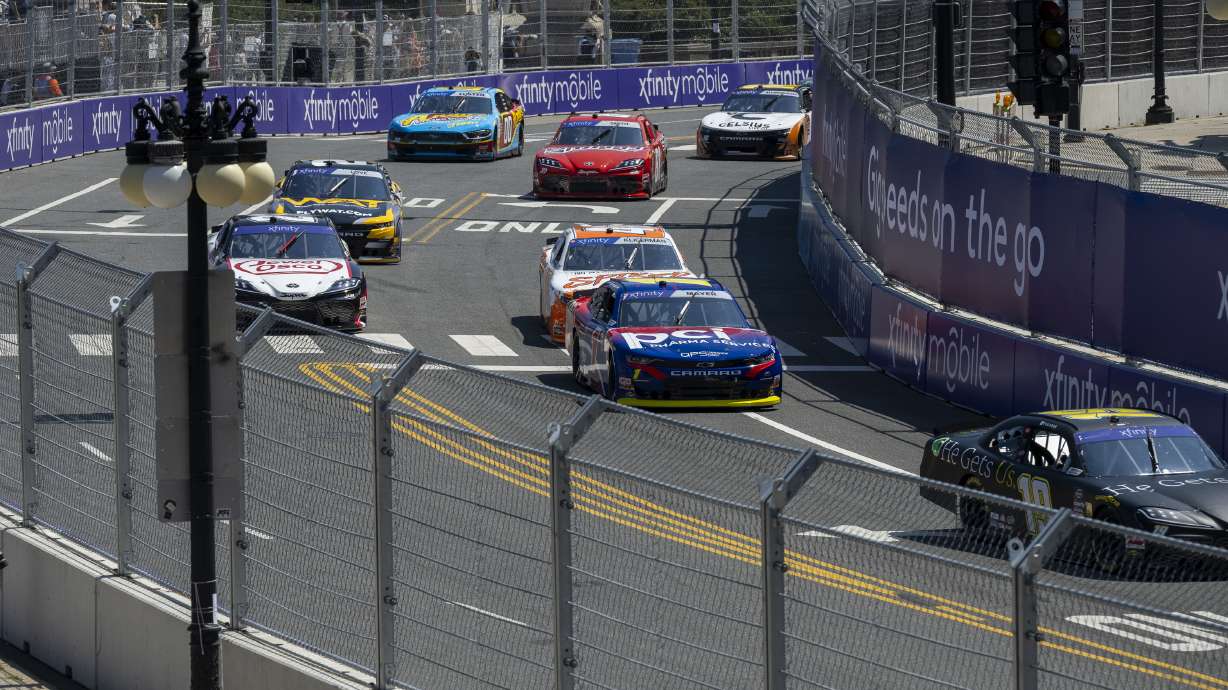Cars navigate turn 19 during a NASCAR Xfinity Series street course auto race in Grant Park, Saturday, July 6, 202 4 in Chicago.