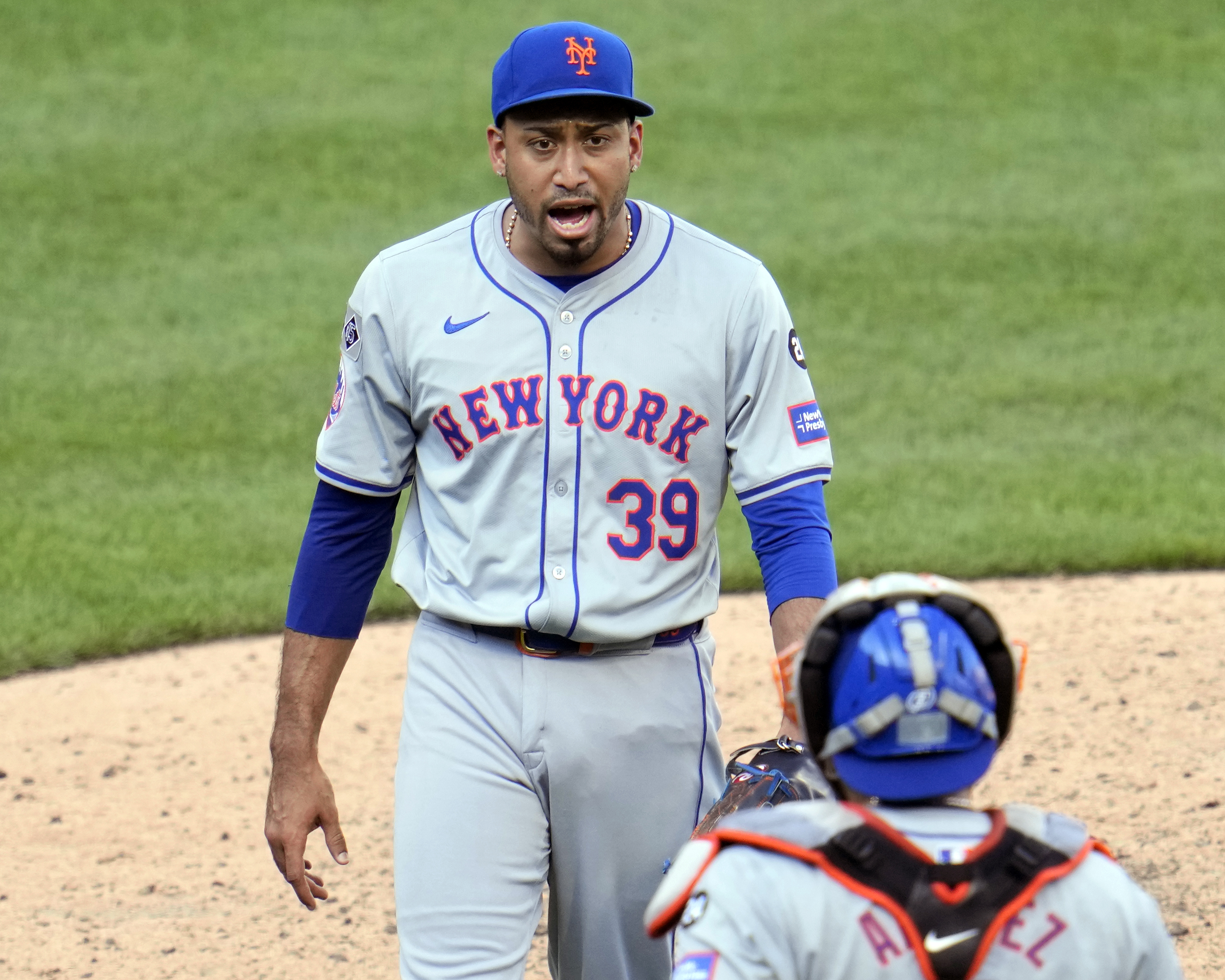 New York Mets relief pitcher Edwin Diaz (39) celebrates with catcher Francisco Alvarez, bottom, after getting the final out of a baseball game against the Pittsburgh Pirates in Pittsburgh, Saturday, July 6, 2024. 