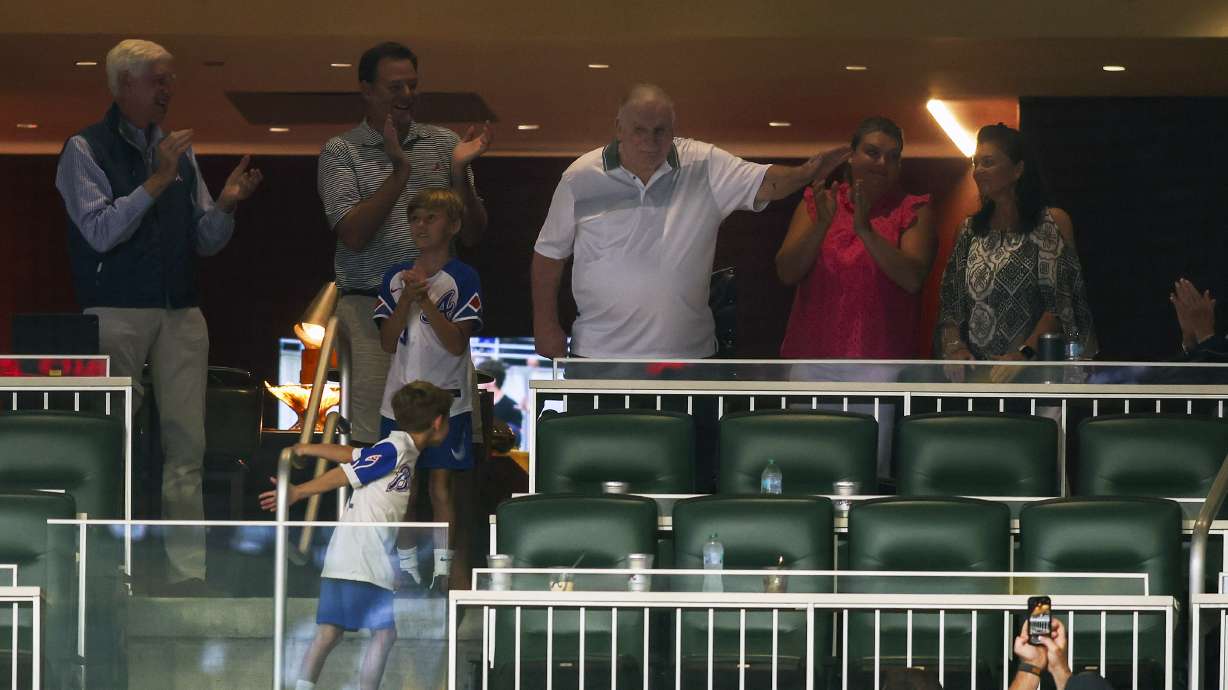 Former Atlanta Braves manager Bobby Cox, center top, waves to the crowd during a baseball game against the Philadelphia Phillies, Saturday, July 6, 2024, in Atlanta.