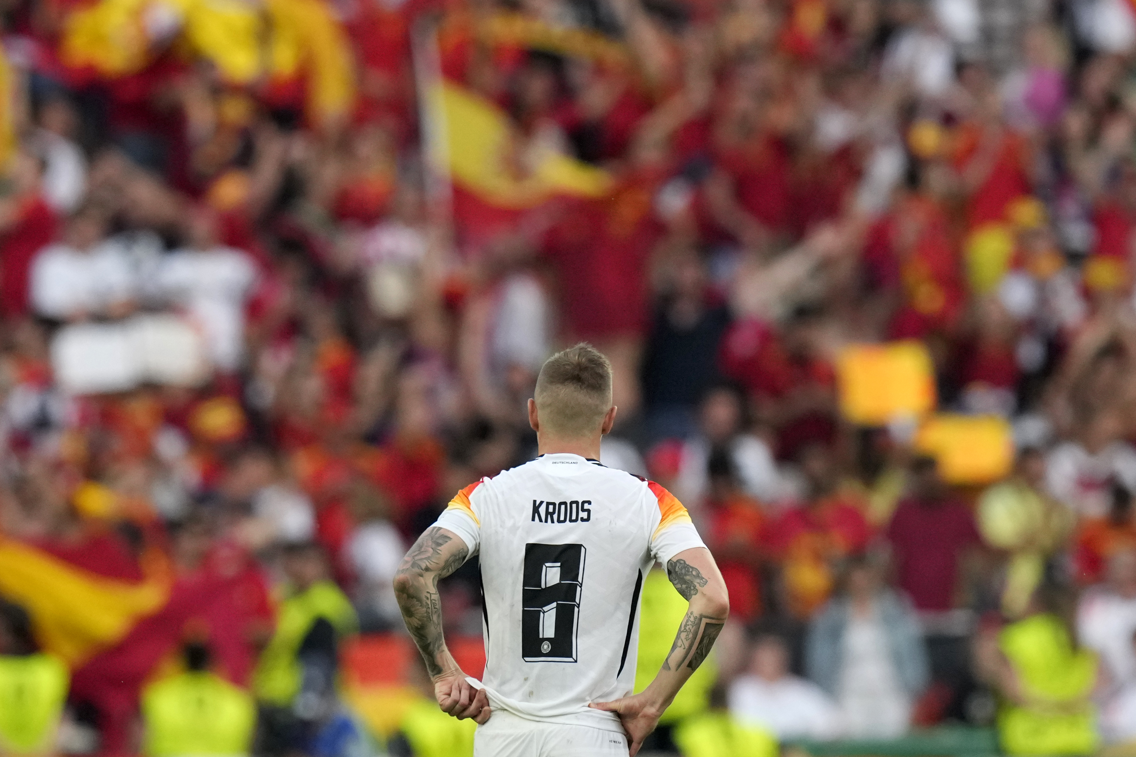 Germany's Toni Kroos watches fans celebrate at the end of a quarter final match between Germany and Spain at the Euro 2024 soccer tournament in Stuttgart, Germany, Friday, July 5, 2024.