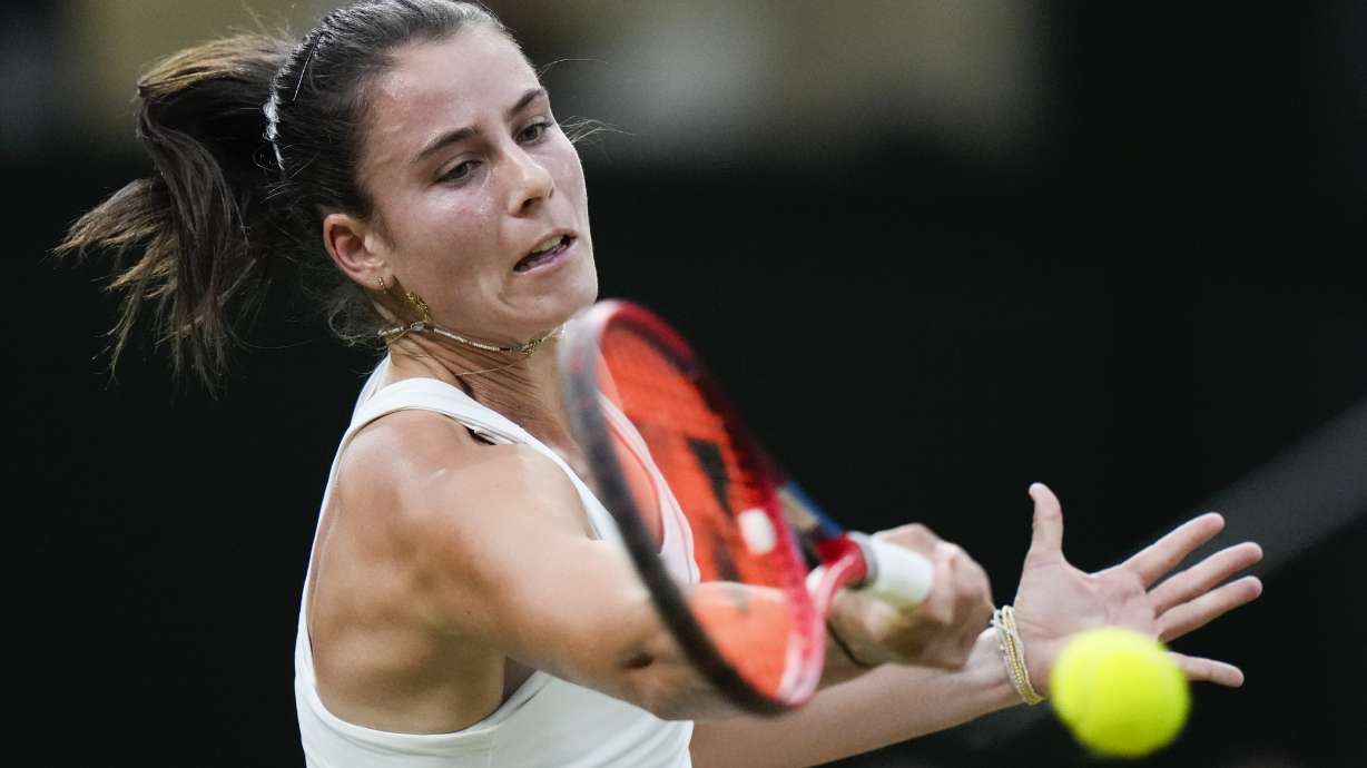 Emma Navarro of the United States plays a forehand return to compatriot Coco Gauff during their fourth round match at the Wimbledon tennis championships in London, Sunday, July 7, 2024.