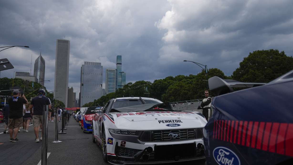 Cars are lined up along Pit Row before a NASCAR Cup Series auto race, Sunday, July 7, 2024, in Chicago.
