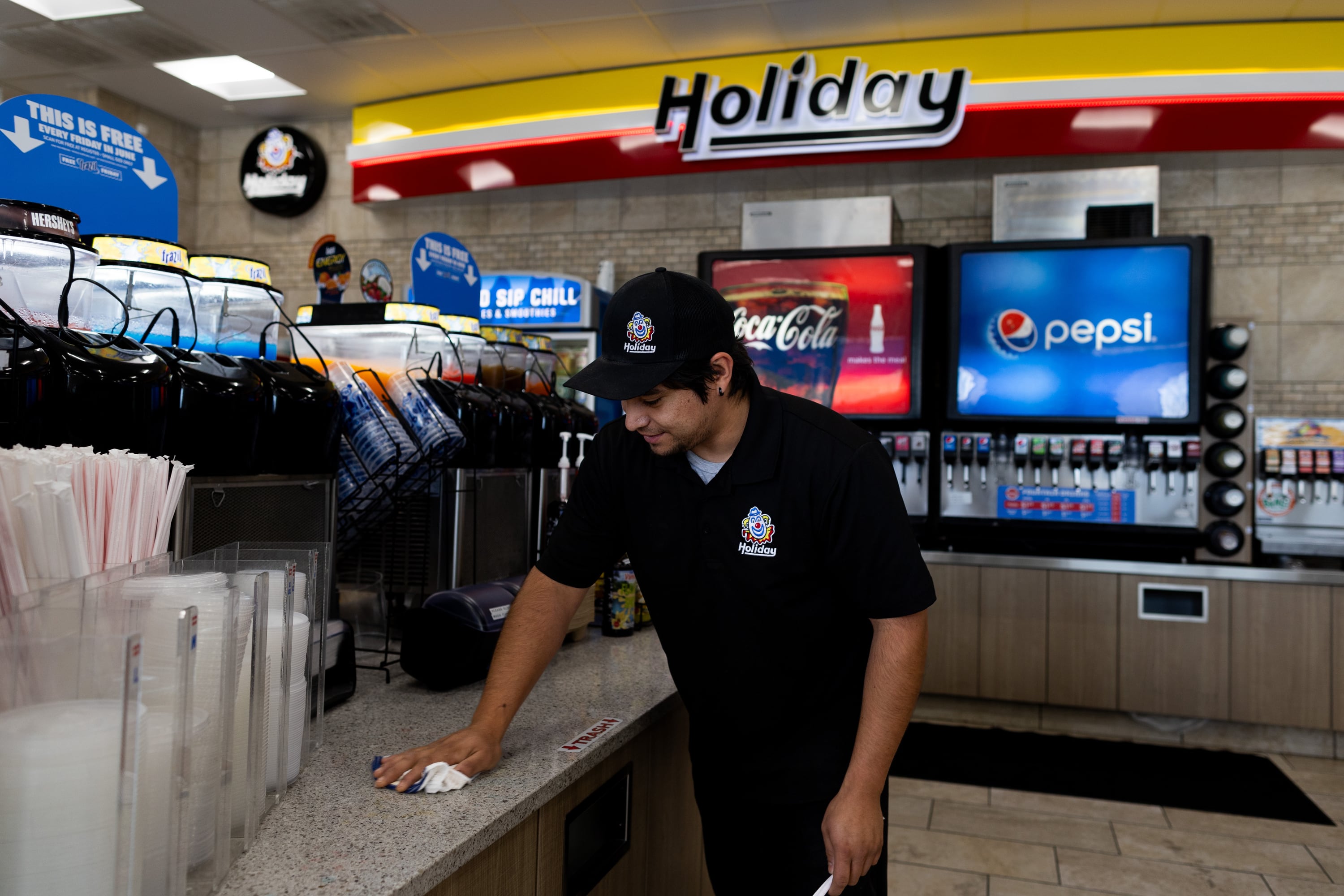 Daniel Garcia, an employee of Holiday for six years, wipes the counters by the soda bar at a Holiday in Magna on June 27.