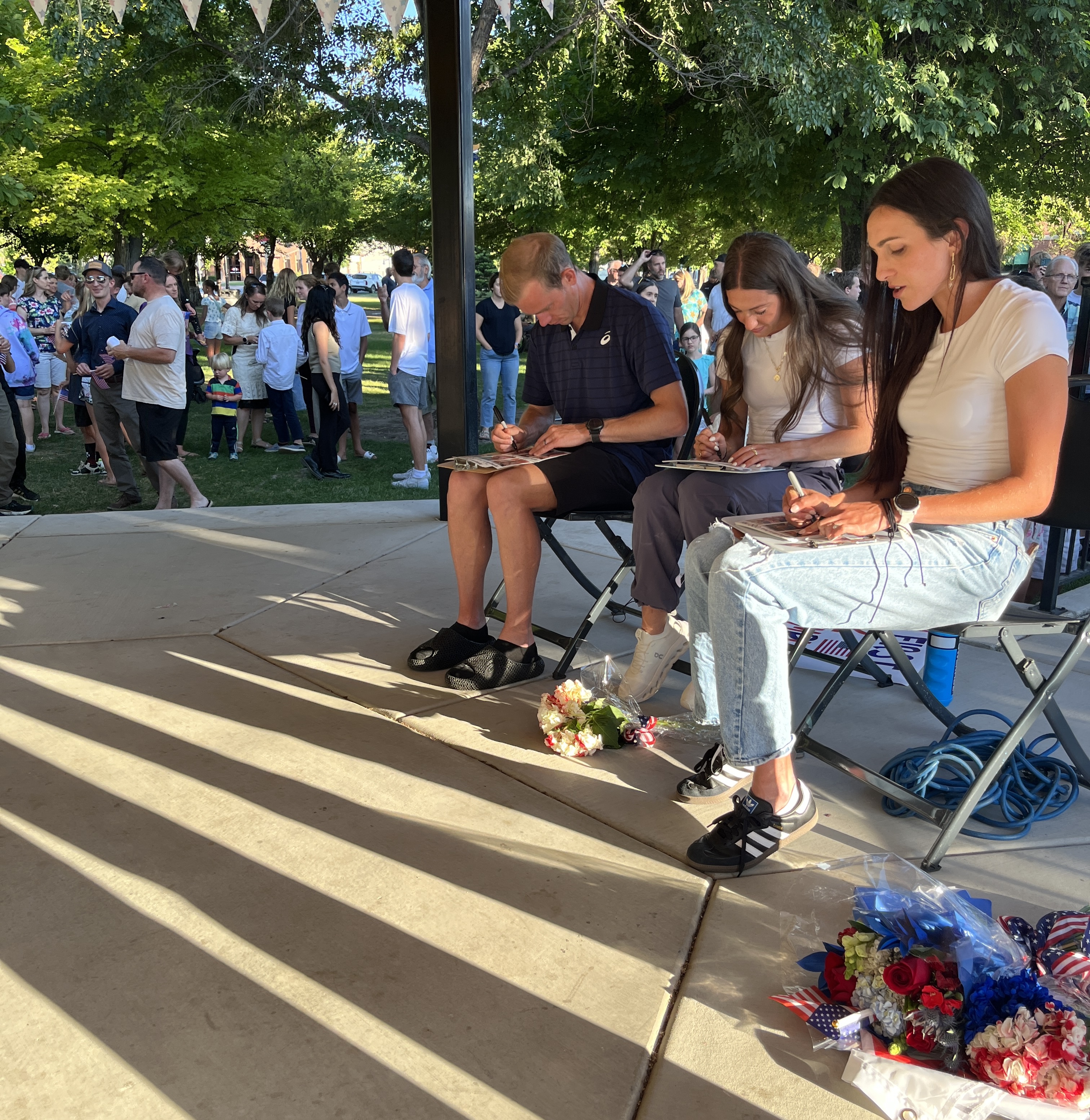 From left to right: Clayton Young, Courtney Waymente, and Whittni Orton Morgan sign autographs for more than a hundred fans in Springville as part of the Team USA delegation for the Summer Olympics in Paris next month.