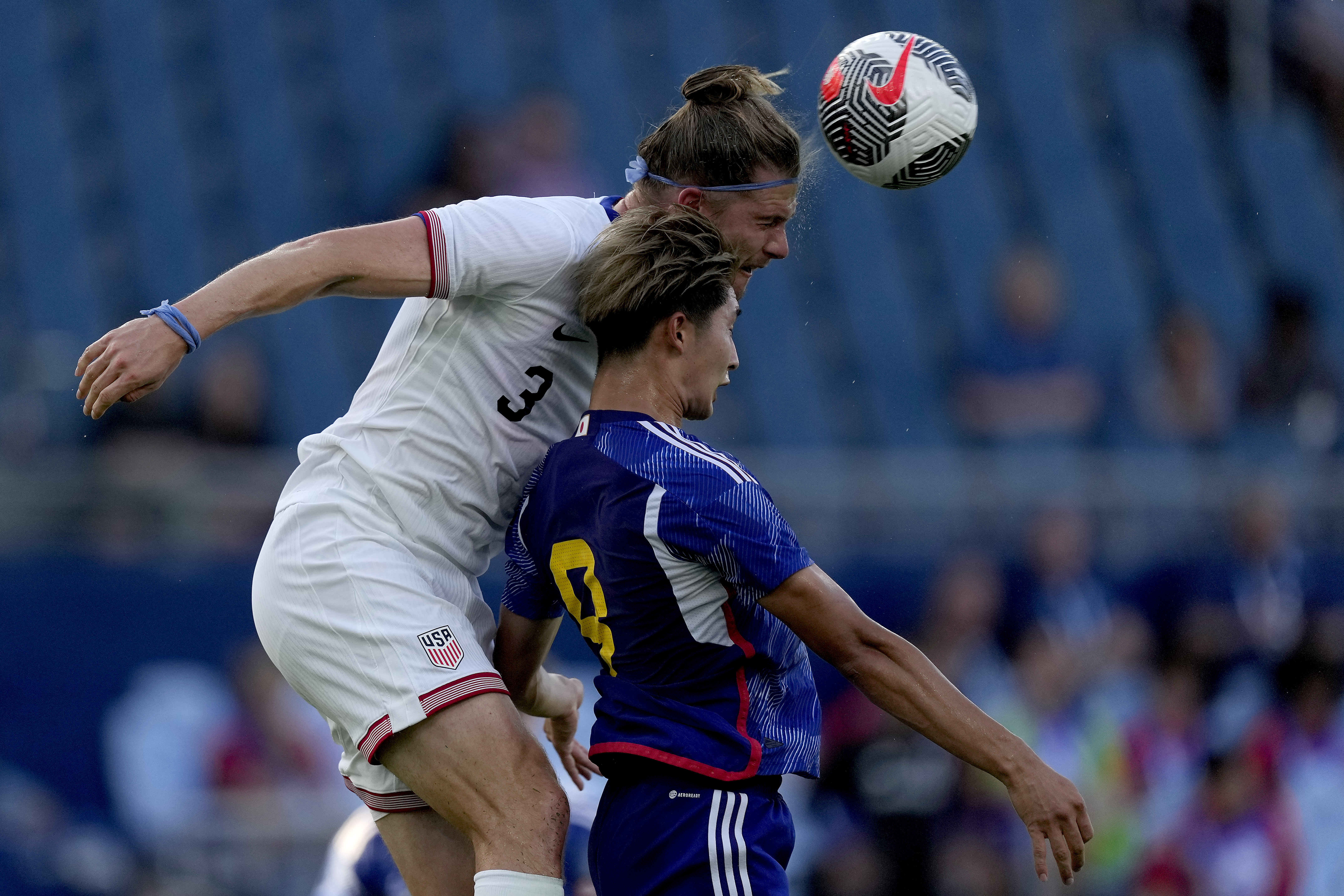 United States defender Walker Zimmerman (3) beats Japan forward Shota Fujio (9) to the ball during the first half of an international friendly under-23 soccer match Tuesday, June 11, 2024, in Kansas City, Kan. 