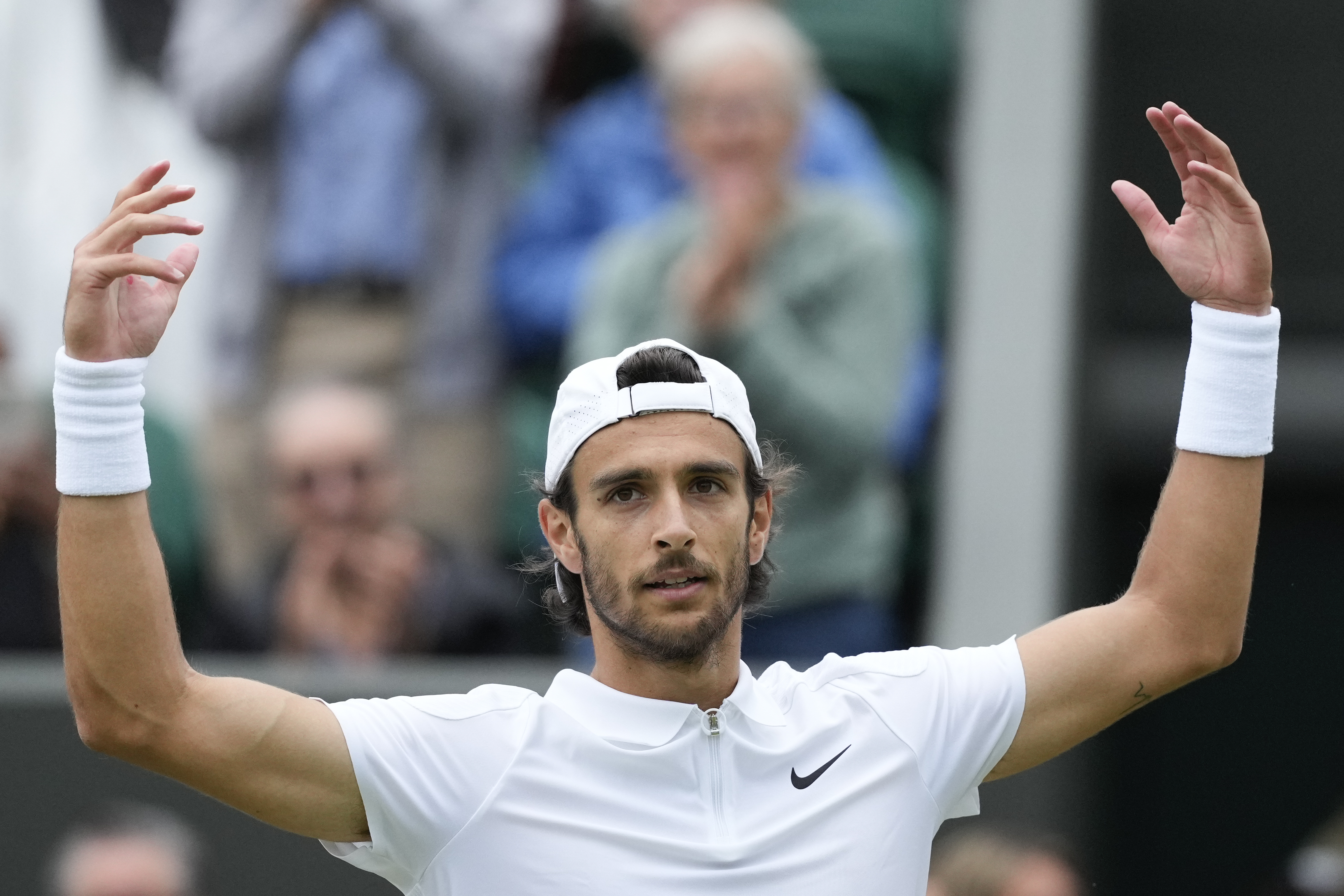 Lorenzo Musetti of Italy celebrates after defeating Giovanni Mpetshi Perricard of France in their fourth round match at the Wimbledon tennis championships in London, Monday, July 8, 2024.
