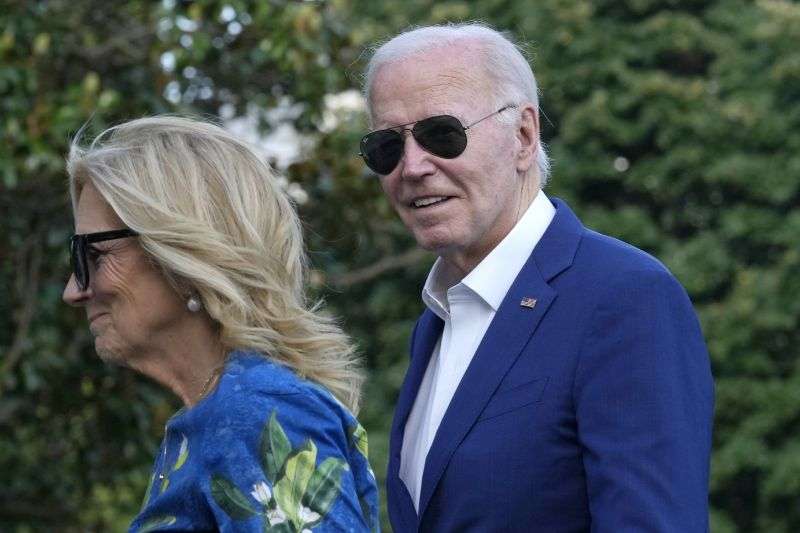 President Joe Biden smiles as he is asked questions by members of the media as he and first lady Jill Biden return on Marine One on the South Lawn of the White House in Washington on Sunday after attending events in Pennsylvania.