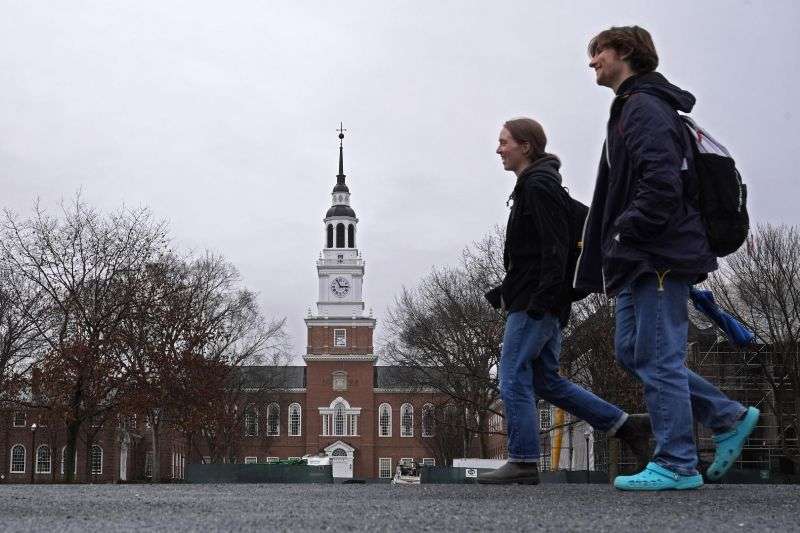 Students cross the campus of Dartmouth College, March 5, in Hanover, N.H. Americans are increasingly skeptical about the value and cost of college, with most saying they feel the U.S. higher education system is headed in the “wrong direction,” according to a new poll.