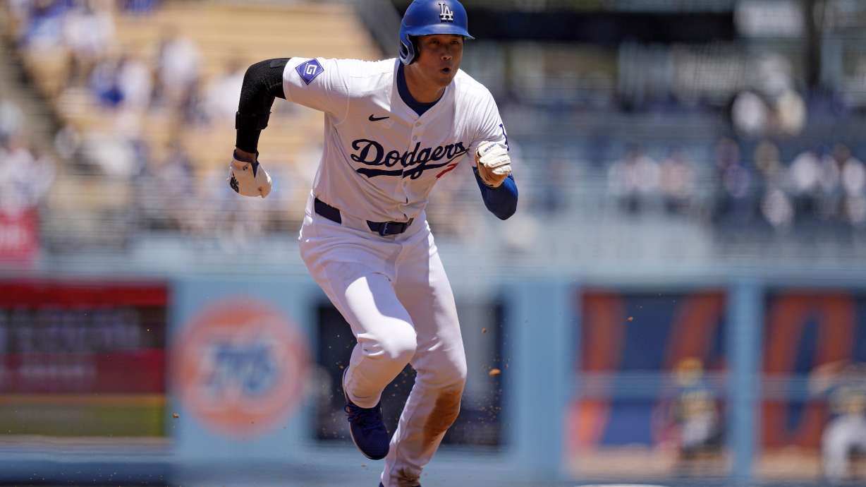 Los Angeles Dodgers' Shohei Ohtani steals third during the third inning of a baseball game against the Milwaukee Brewers Sunday, July 7, 2024, in Los Angeles.