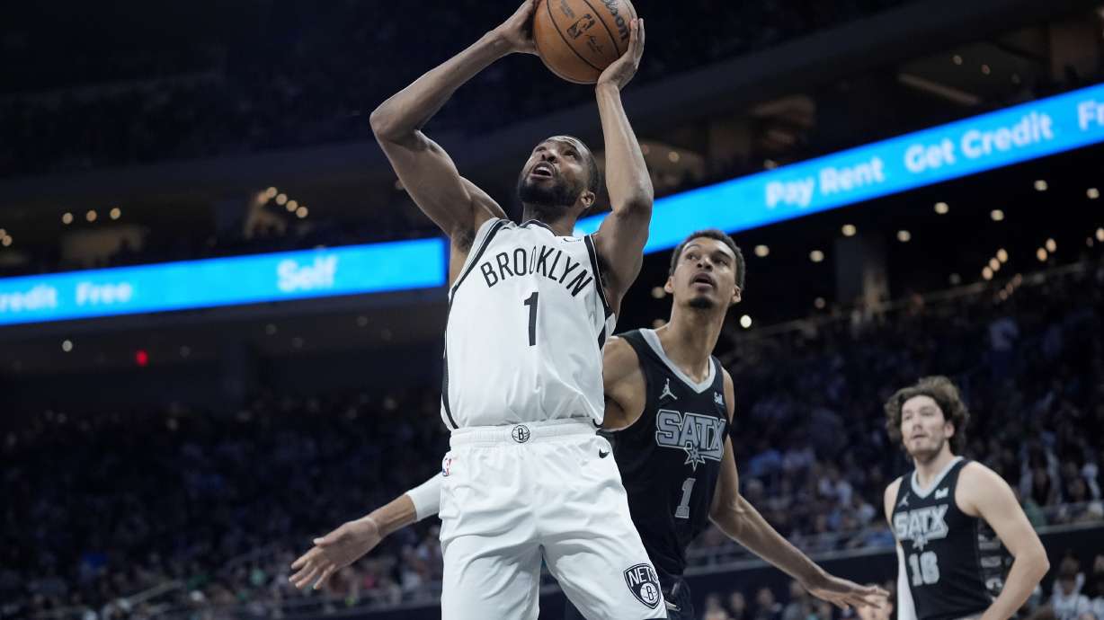 FILE - Brooklyn Nets forward Mikal Bridges, left, scores past San Antonio Spurs center Victor Wembanyama, center, during the first half of an NBA basketball game in Austin, Texas, March 17, 2024. Bridges is being traded from the Nets to the New York Knicks, where he will join Jalen Brunson and other former Villanova teammates, a person with knowledge of the details said Tuesday, June 25.