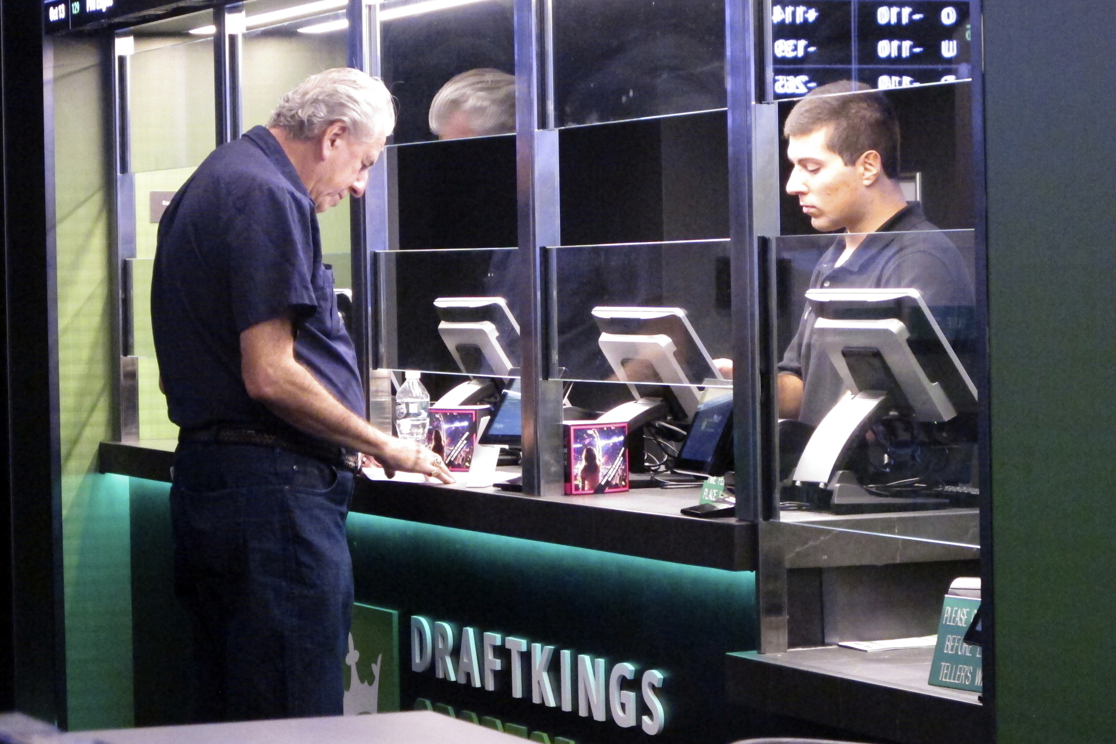 A man makes a sports bet at the DraftKings sports book in Atlantic City, N.J., Oct. 8, 2019. New Jersey regulators fined DraftKings $100,000 on June 17, 2024 for reporting inaccurate sports betting data to the state, leading to the correction and reposting of New Jersey sports betting data in Dec. 2023 and January and Feb. 2024. 