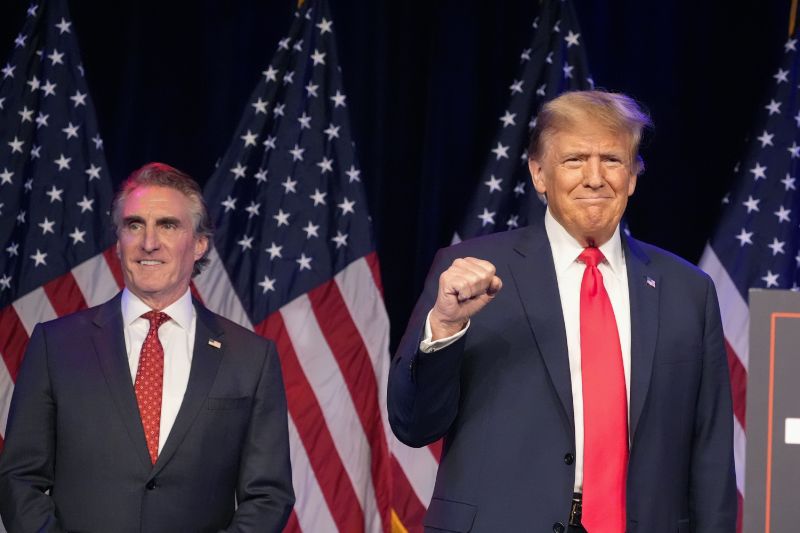 Republican presidential candidate former President Donald Trump, right, and North Dakota Gov. Doug Burgum attend a caucus night rally, Feb. 8, in Las Vegas.