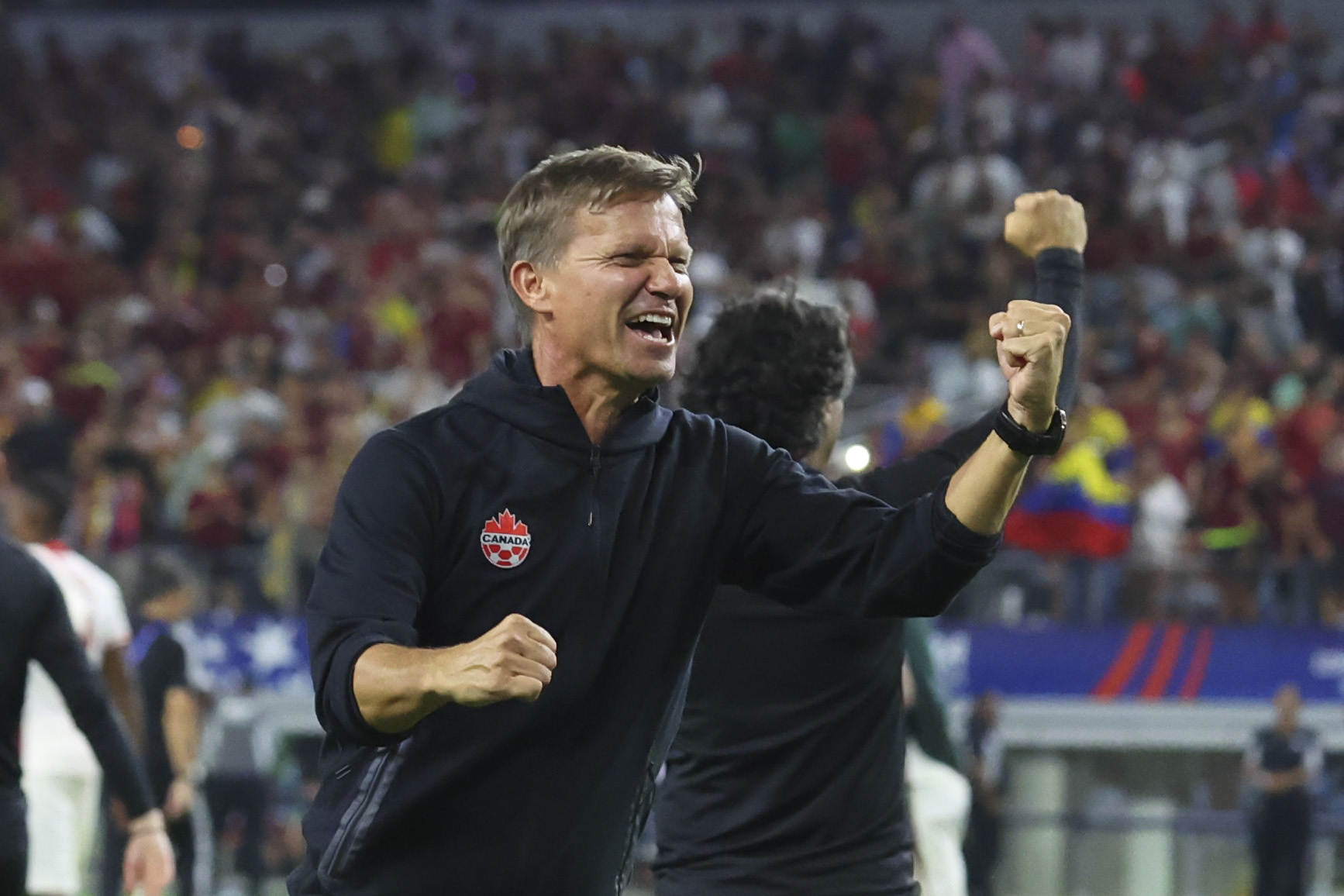Canada head coach Jesse Marsch celebrates the team's win in a Copa America quarterfinal soccer match between Venezuela and Canada in Arlington, Texas, Friday, July 5, 2024. 