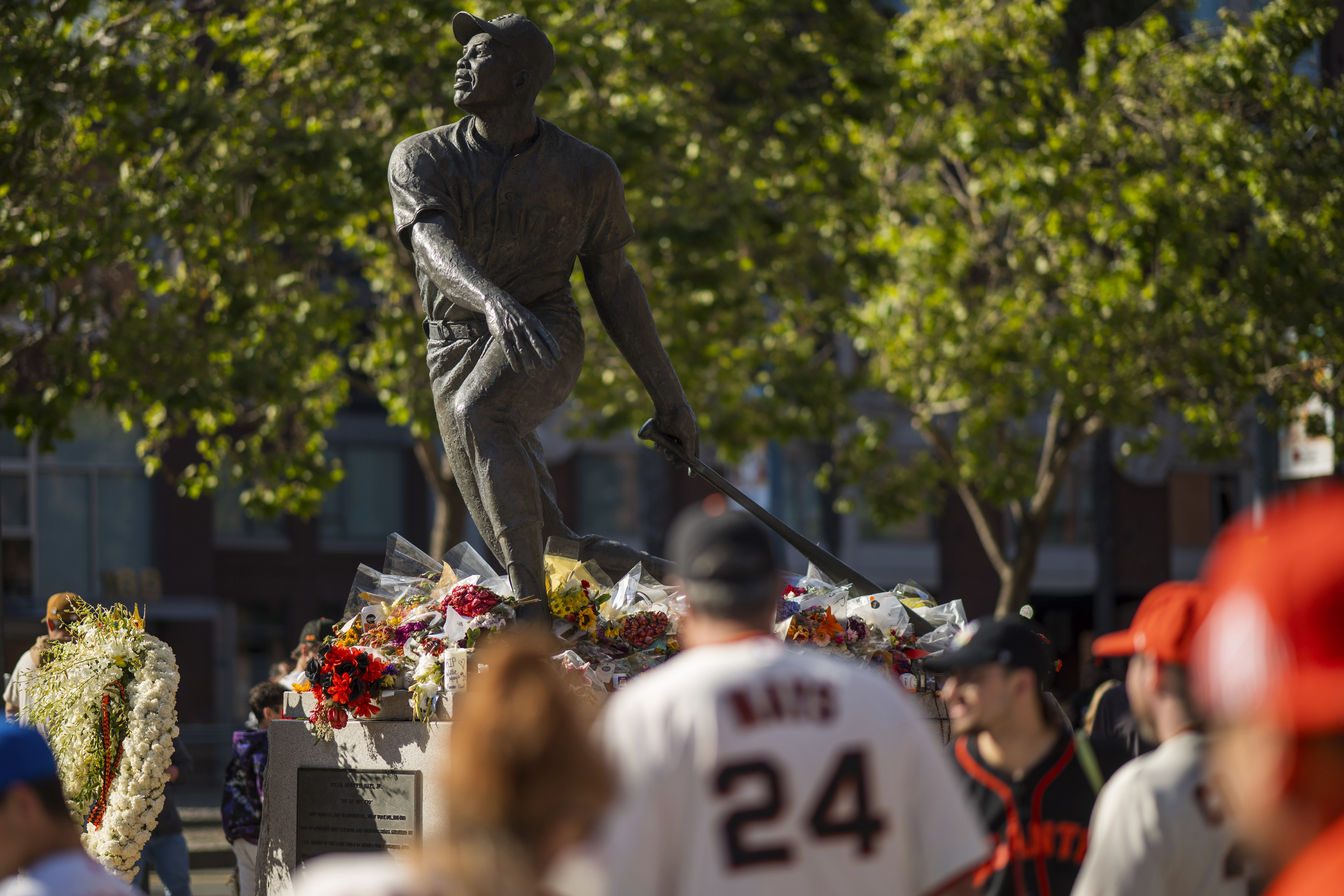 Fans walk by a tribute for the late Willie Mays before a baseball game between the San Francisco Giants and the Chicago Cubs in San Francisco, Tuesday, June 25, 2024. 