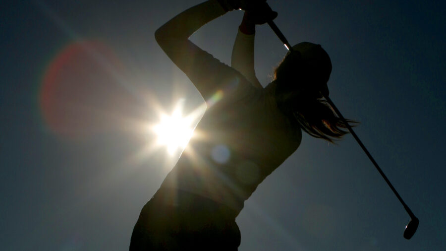 A golfer is silhouetted against the sun at Royal Lytham and St Annes golf course in Lytham, northwest England, Aug. 3, 2006. Most Utahns are trying to figure out how to stay inside and avoid the 105-degree heat forecast this week. But not golfers.