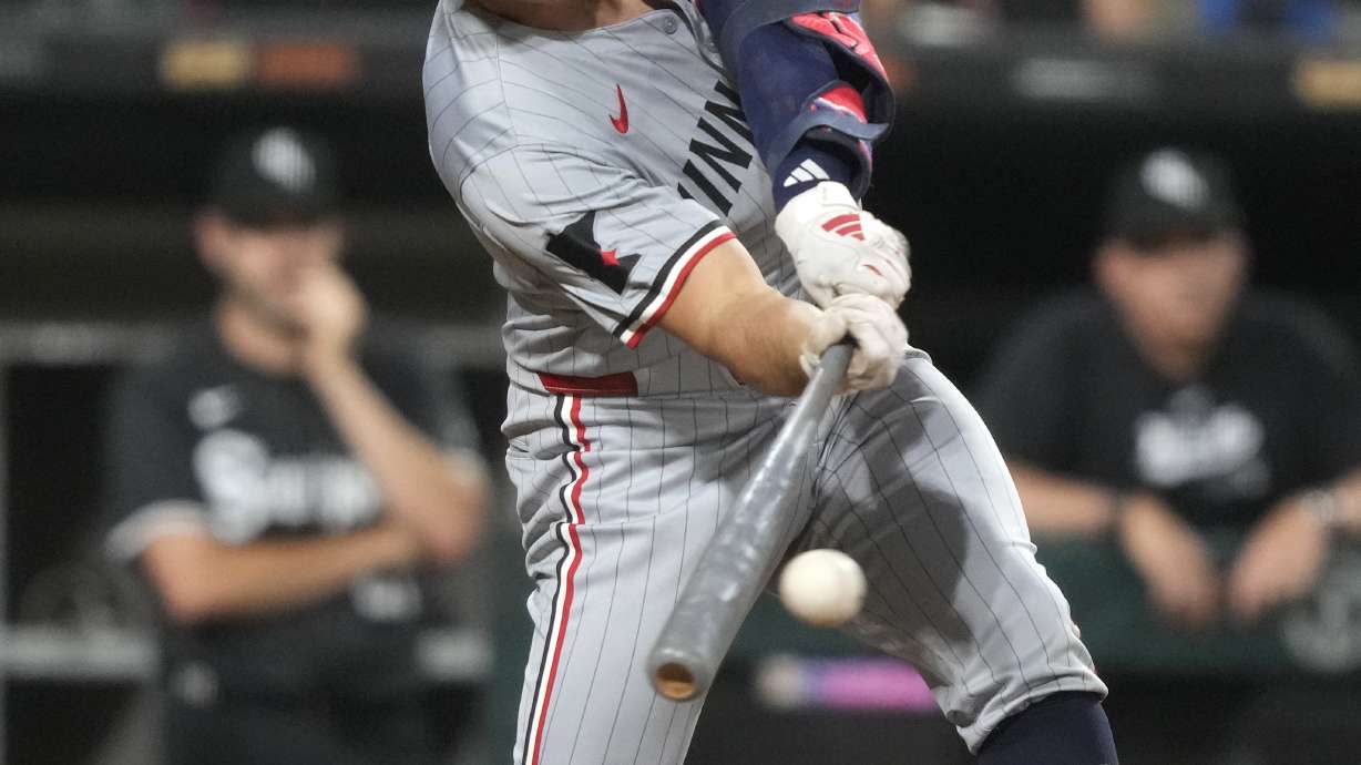 Minnesota Twins' Brooks Lee hits an RBI single in the 11th inning of a baseball game against the Chicago White Sox, Monday, July 8, 2024, in Chicago.